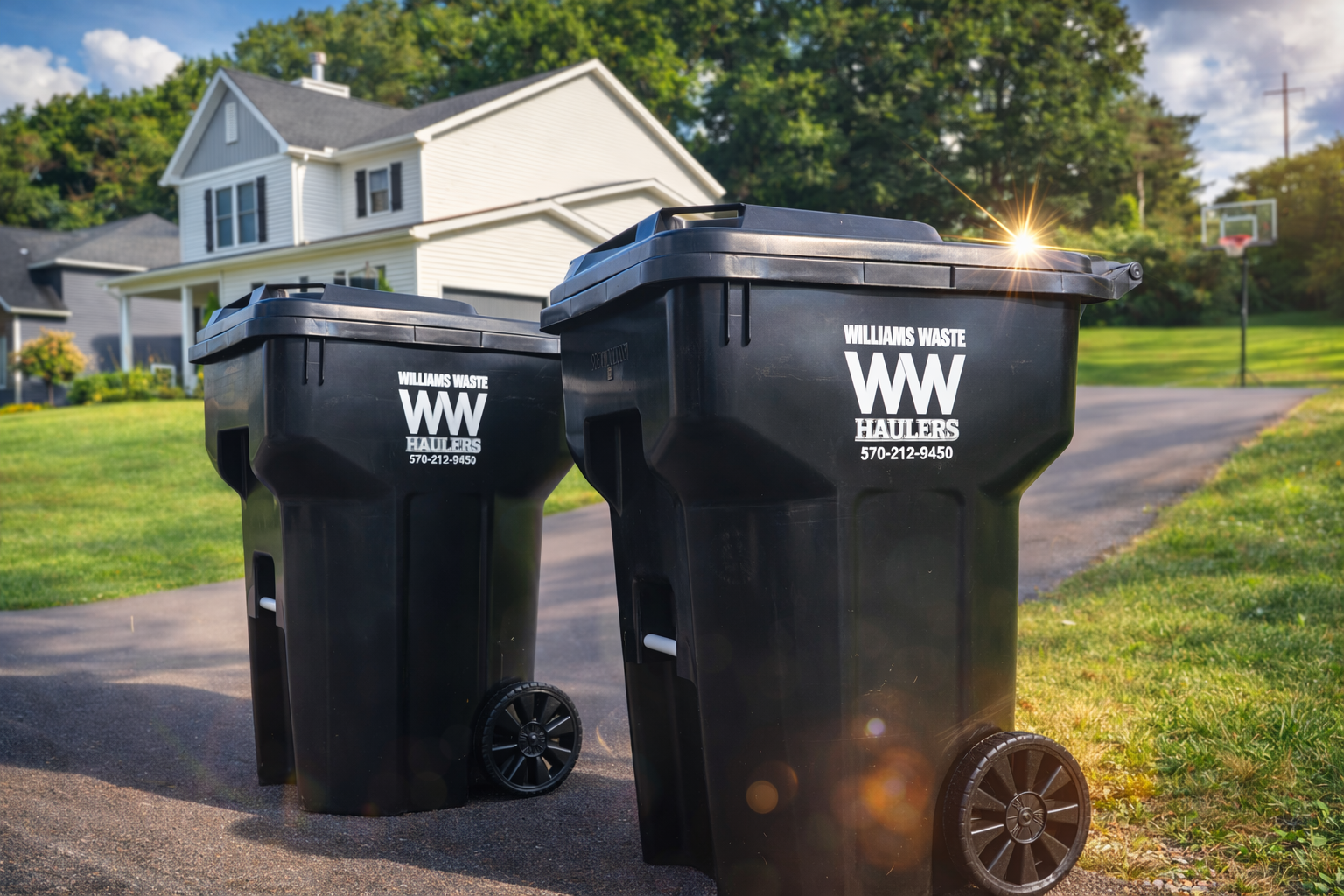 Residential trash and recycling bins by Williams Waste Haulers in Williamsport PA at a curbside home pickup