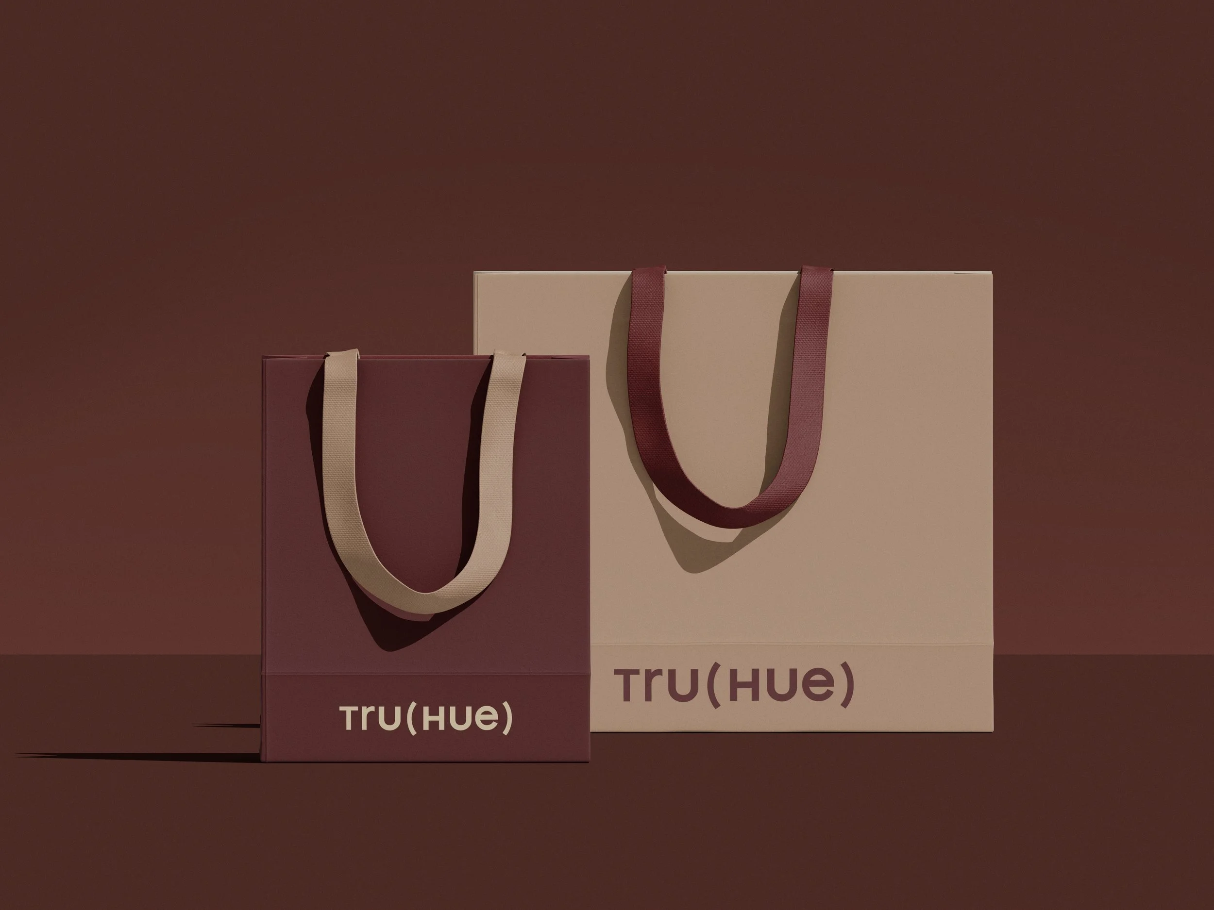 Branded retail shopping bags for TRU(HUE), illustrating luxury cosmetics packaging design and cohesive beauty brand identity.