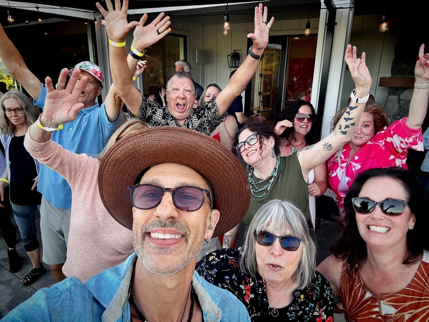 Hit Machine's frontman celebrating with an enthusiastic crowd at a live show