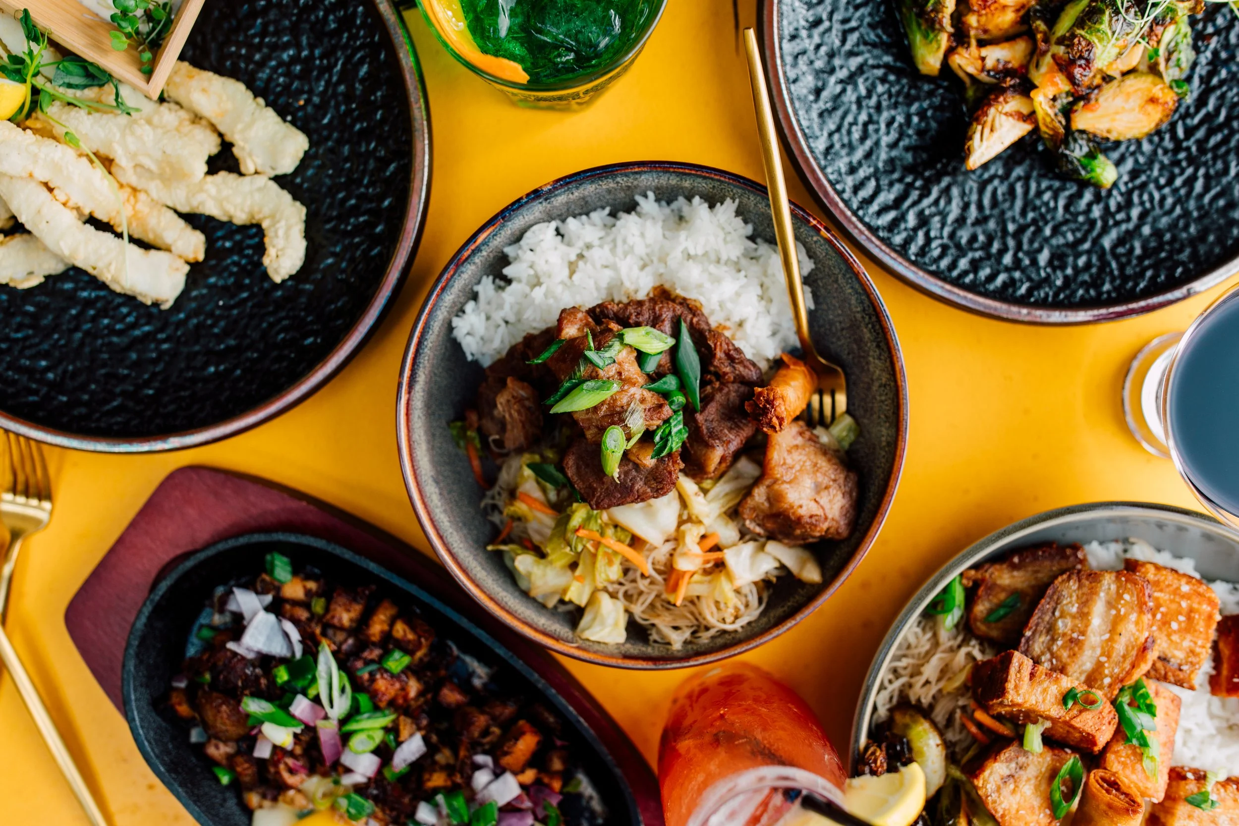Filipino cuisine on a bright yellow restaurant table seattle food photos 