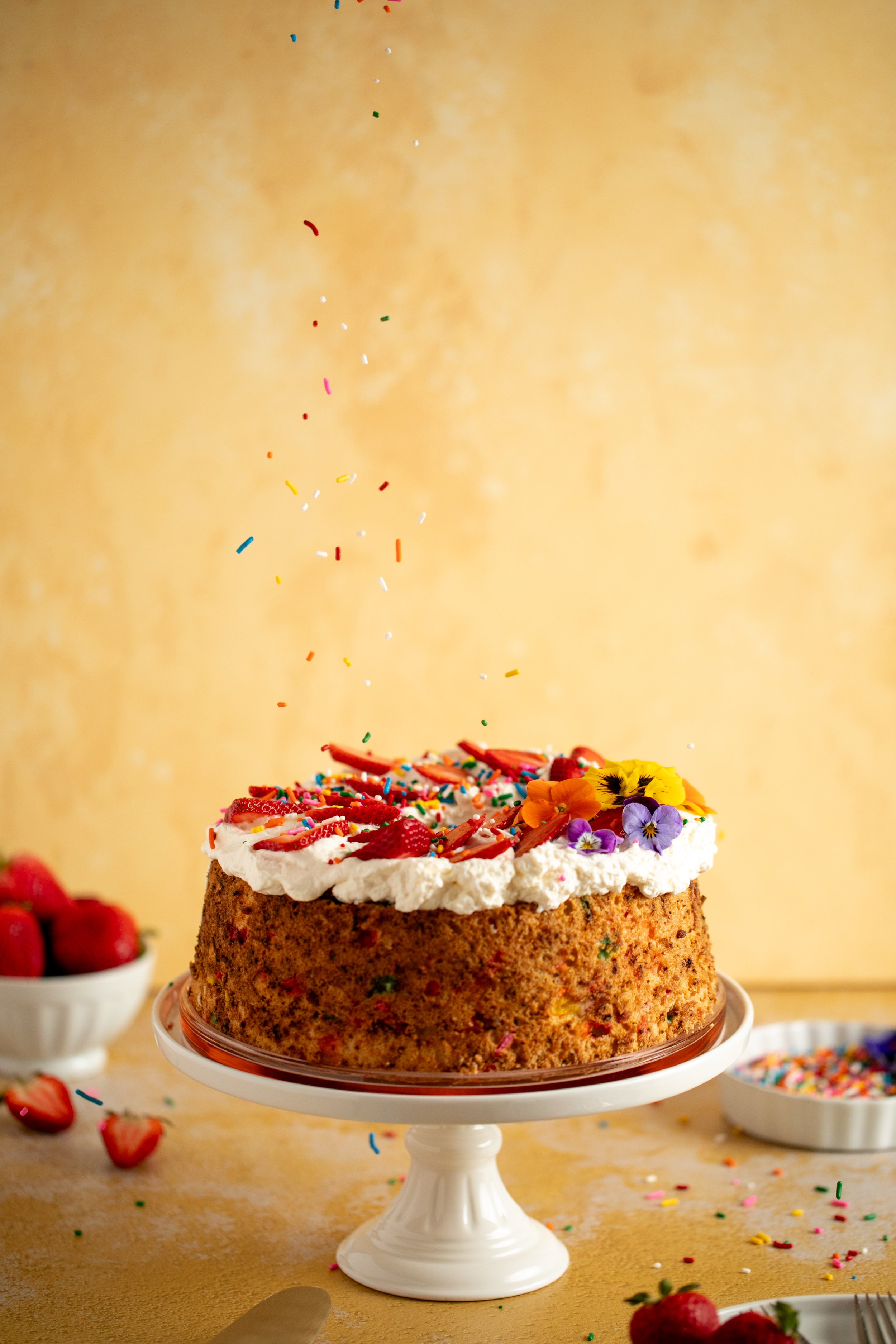 angel food birthday cake colorful sprinkles dropping editorial food dessert photography seattle food photographer
