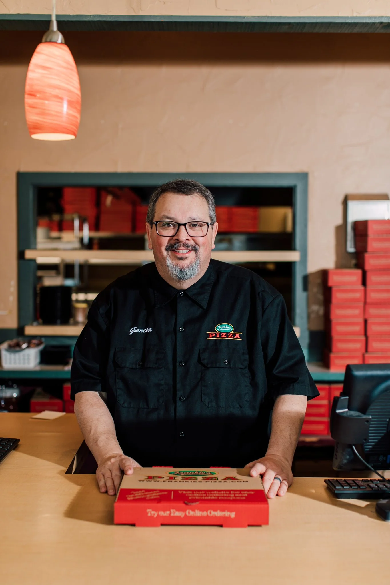 owner of frankies pizza headshot inside pizza restaurant