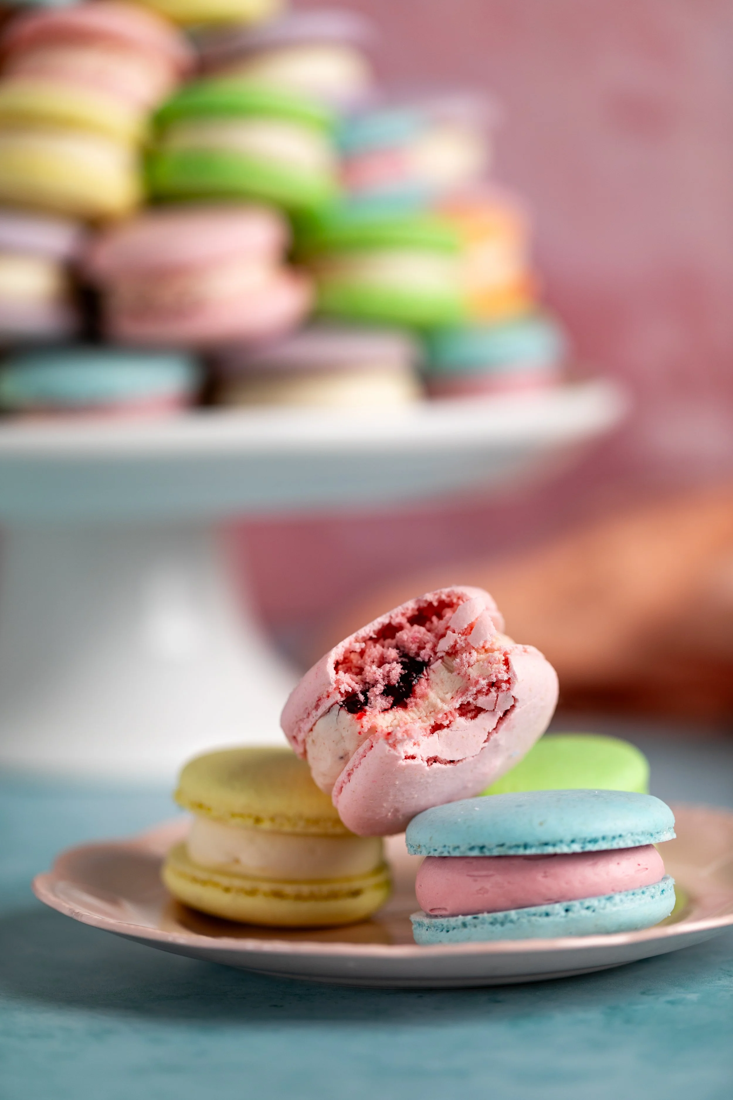 bite out of a pink colorful macaron bakery photography seattle restaurant photographer
