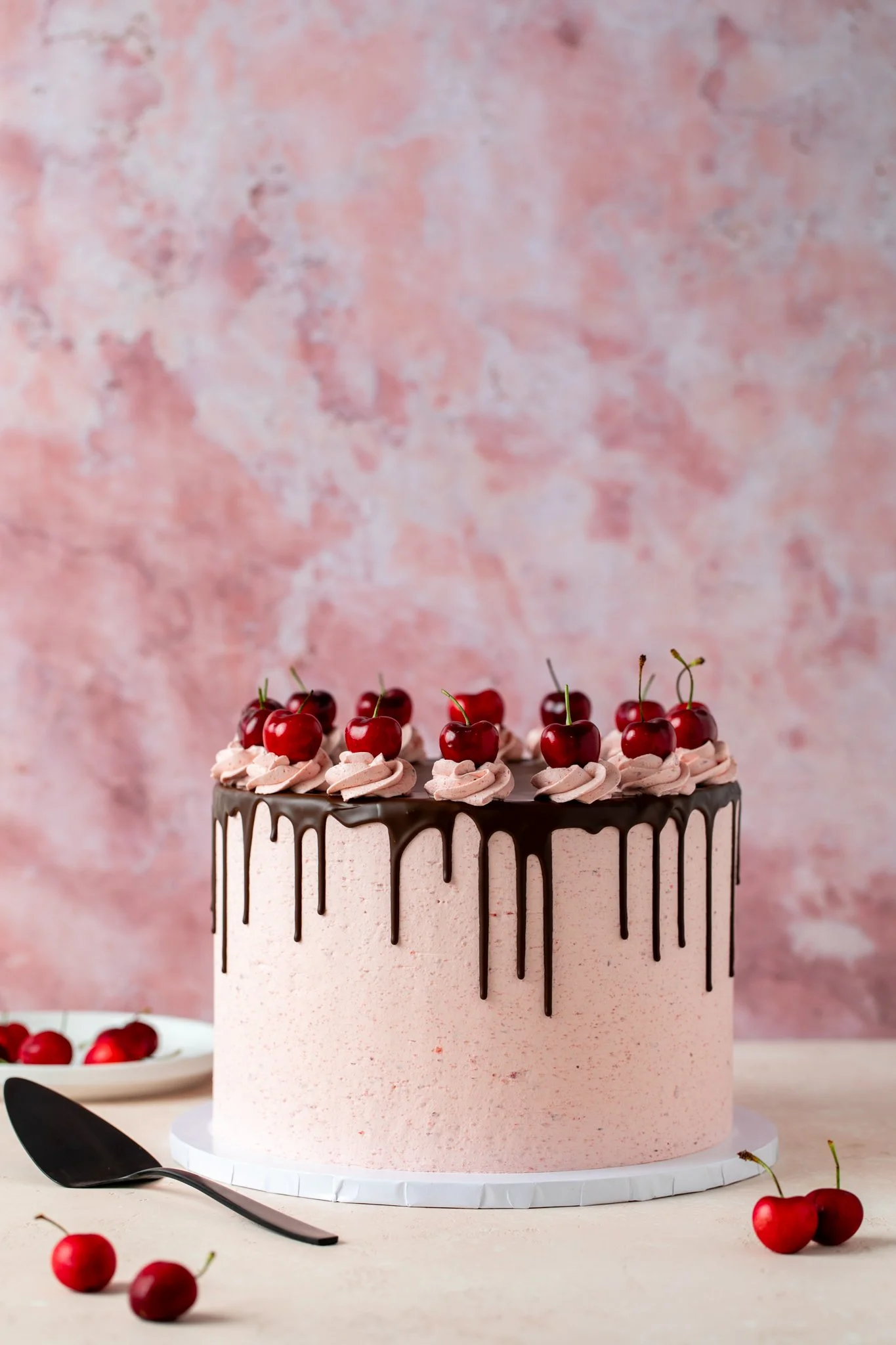 super tall cherry cake dripping in chocolate on a pink background seattle dessert photographer 
