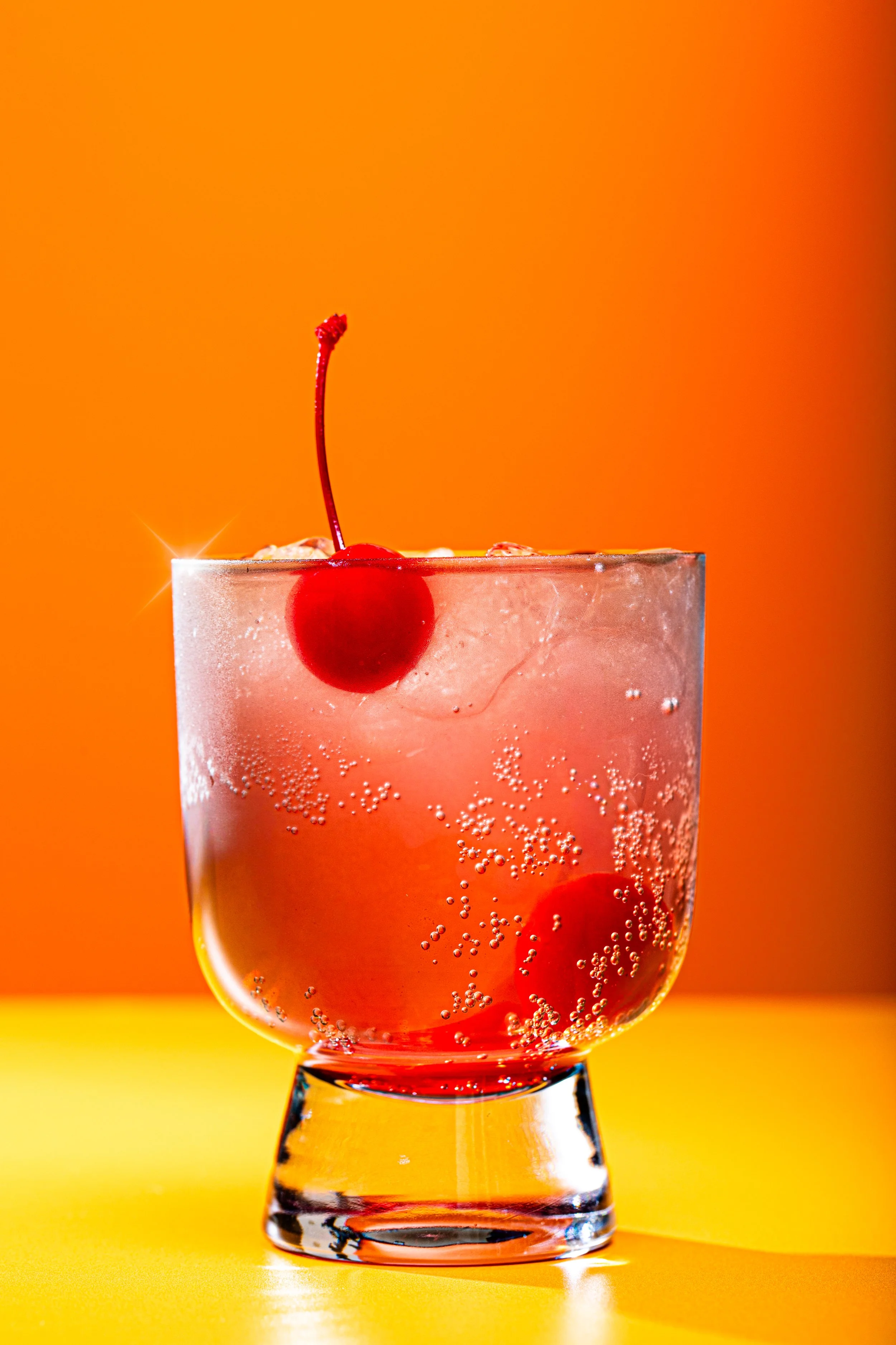 individual cocktail closeup beverage photo colorful warm image with cherry float seattle food and drink photographer