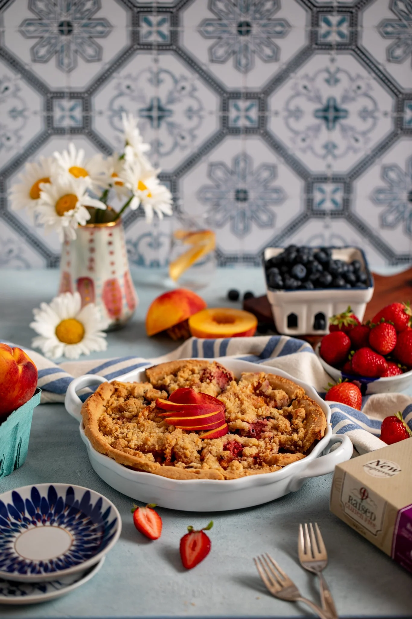 gluten free apple pie plated in baking dish with spring flowers and fresh fruit food photography