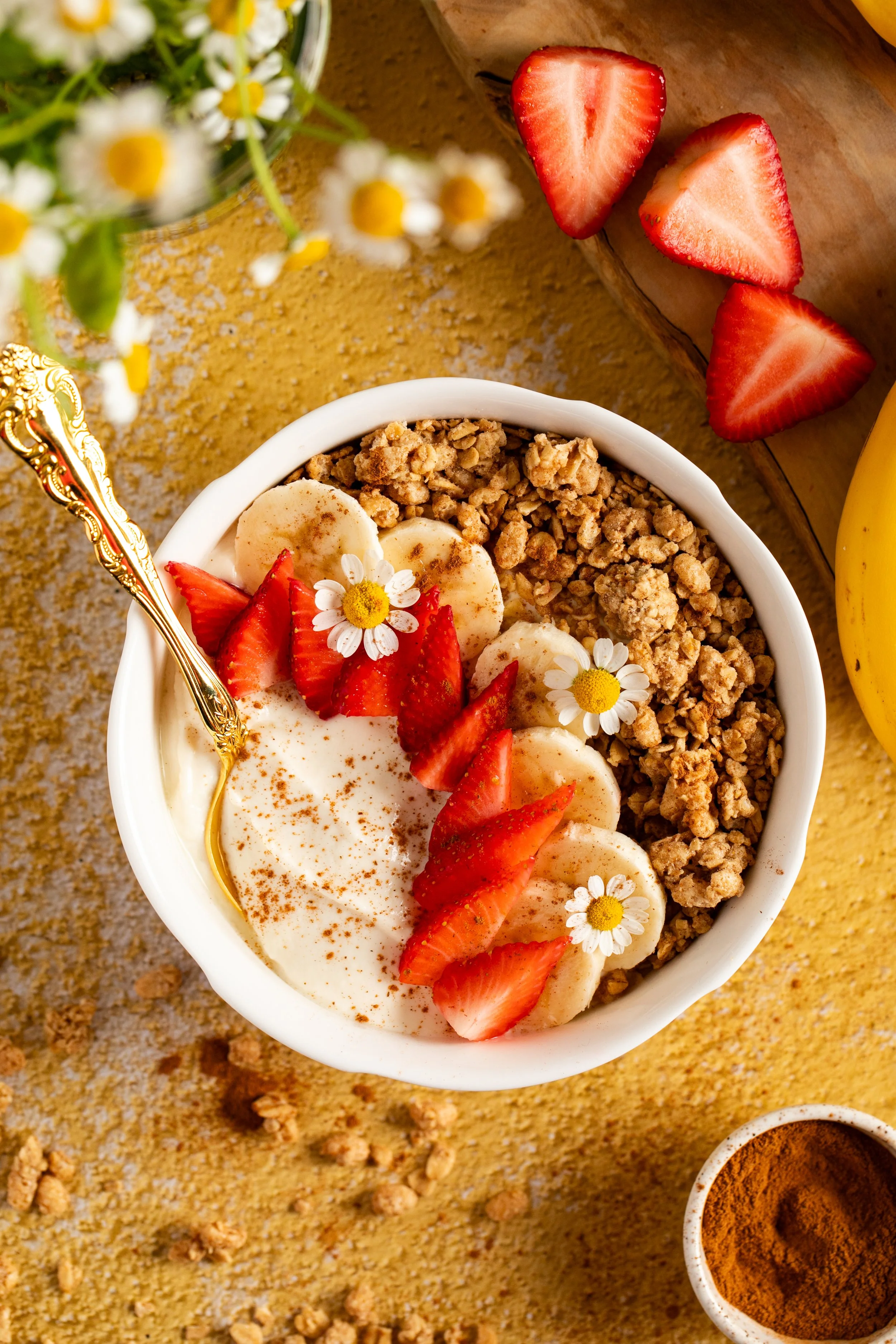 breakfast granola bowl fresh fruit daisies on a summer morning bright background colorful seattle food photographer