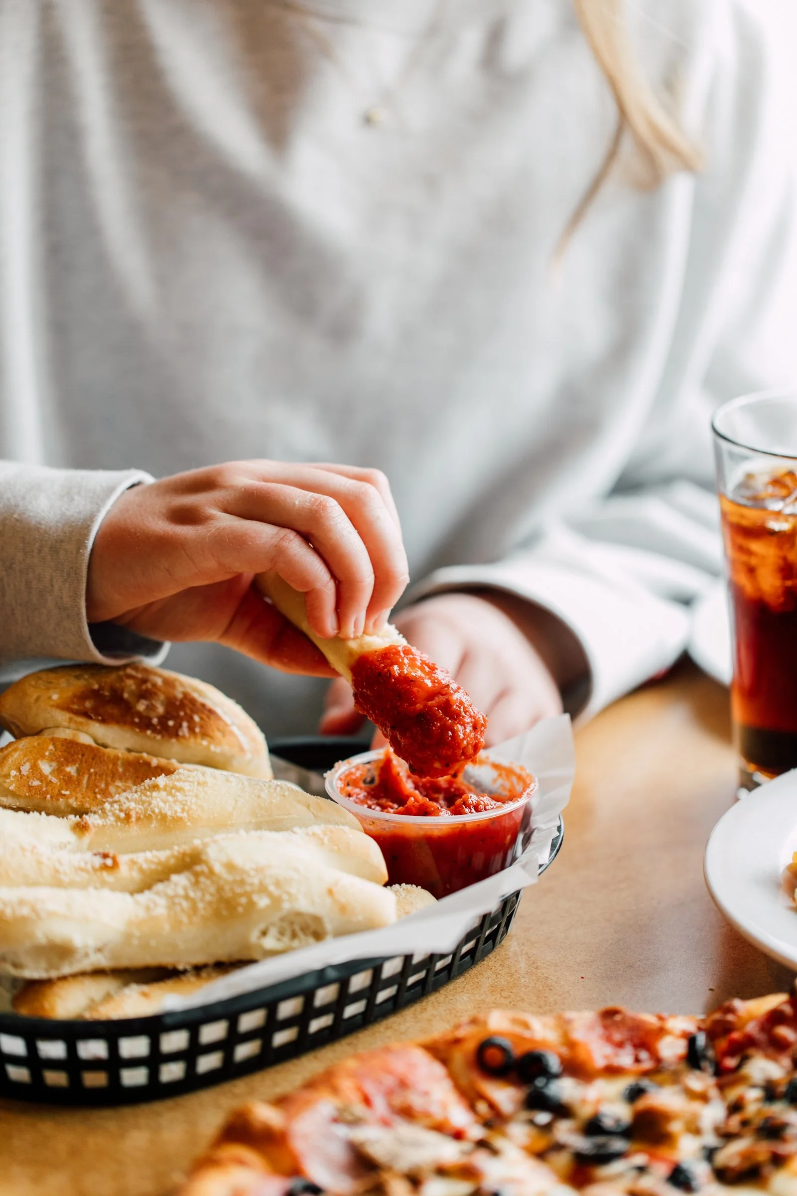 dipping cheese sticks at seattle pizza restaurant in rich red marinara sauce dinner photos