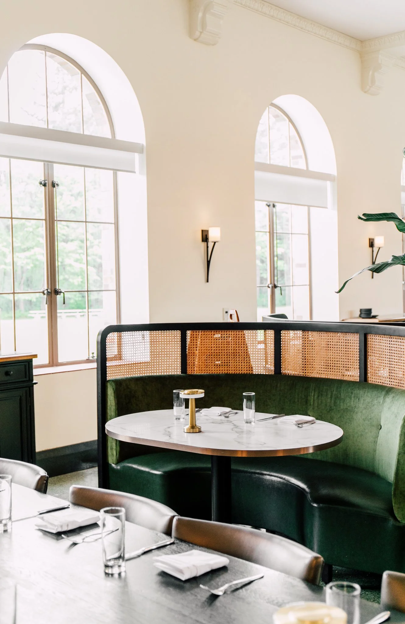 interior restaurant photography photo emerald green benches and marble tables drenched in sunlight