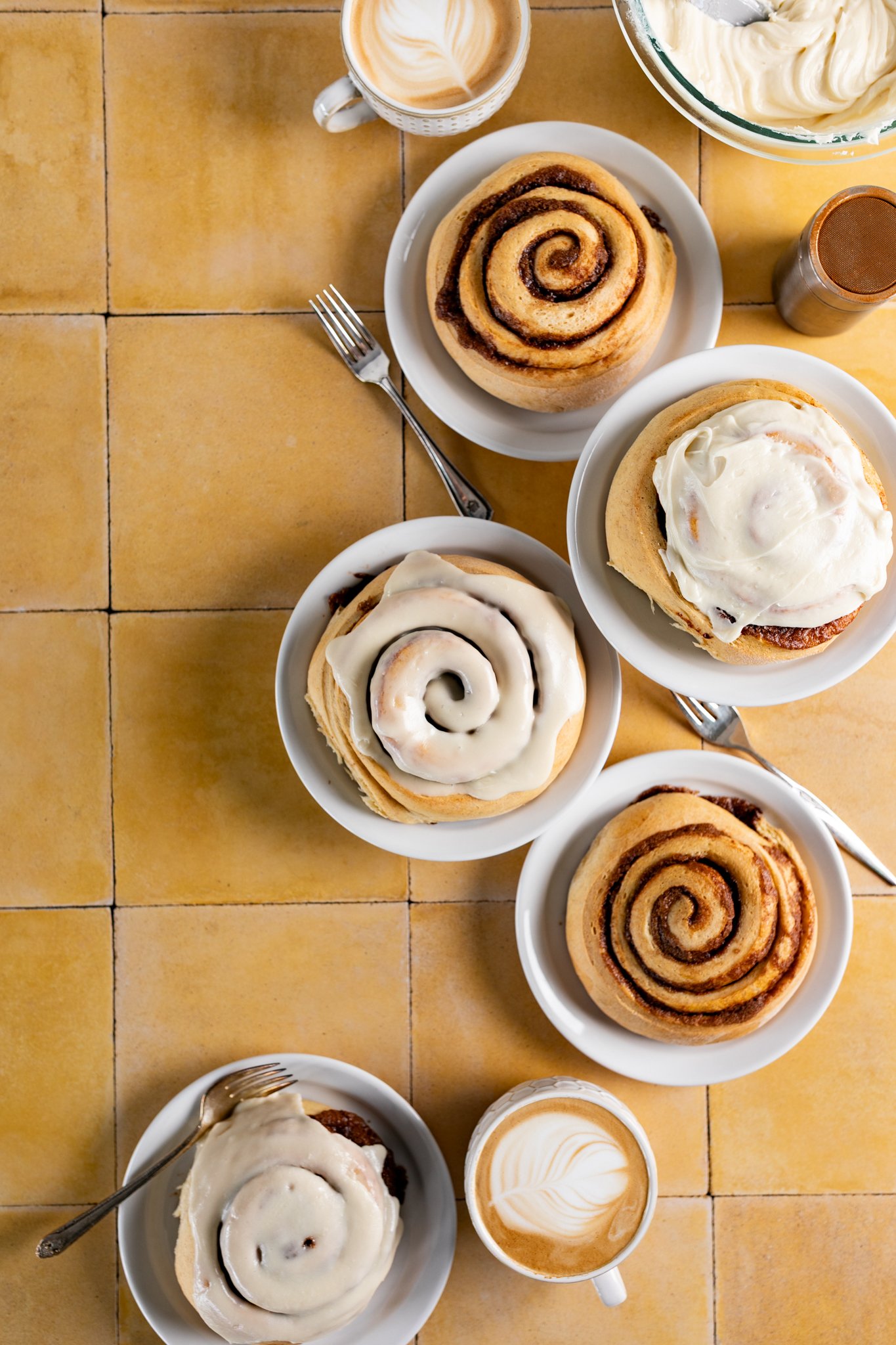 table full of gooey warm cinnamon rolls seattle breakfast pastry photographer 