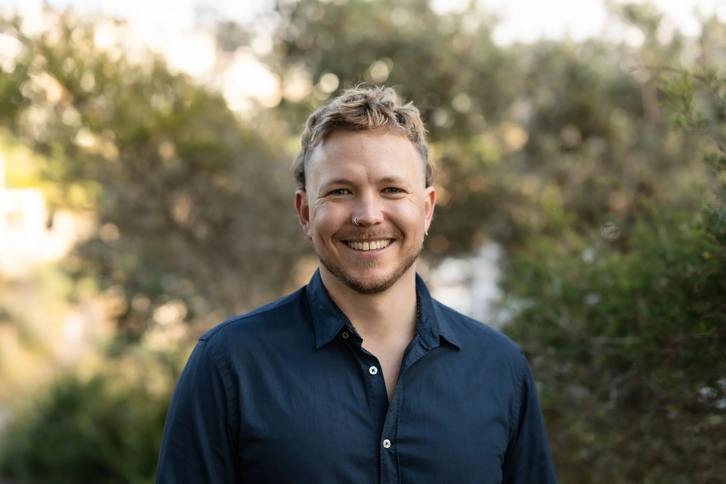 William Wolfenden, founder of LifeFlow Occupational Therapy, smiling outdoors in Sydney