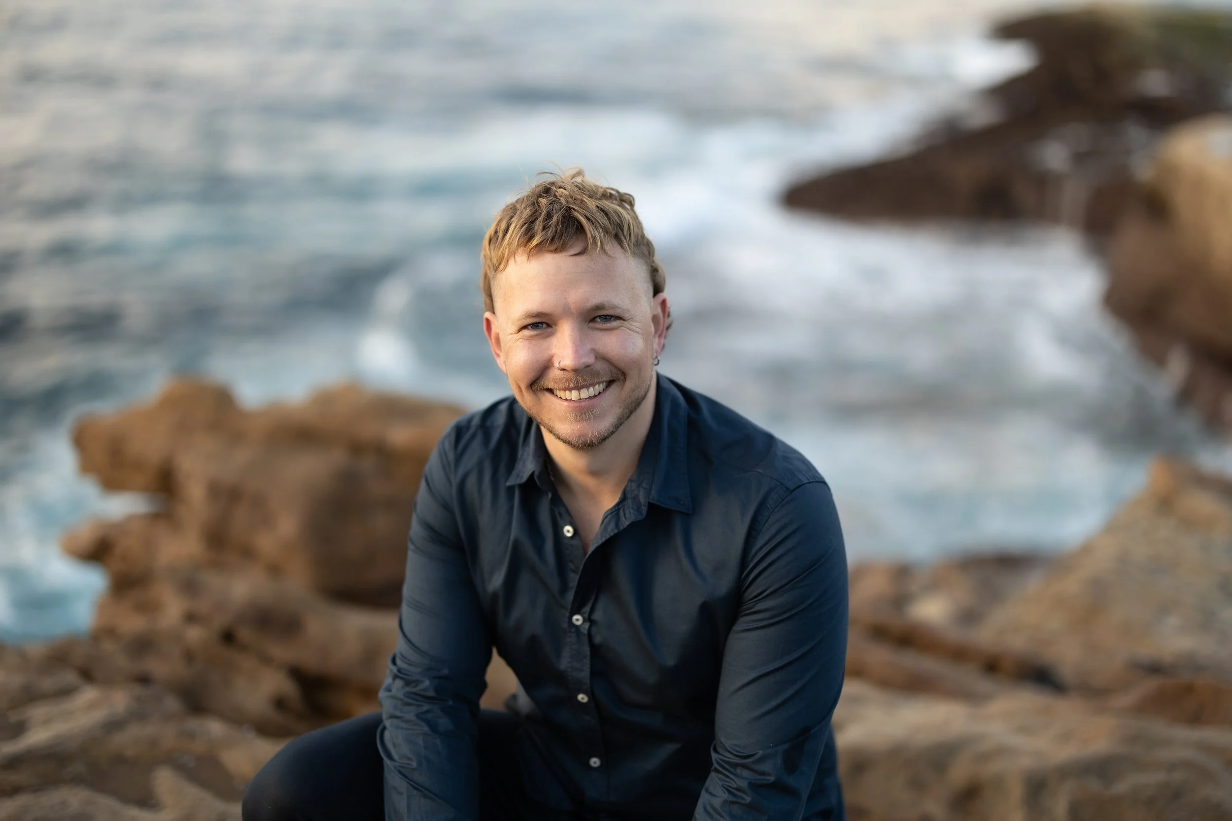 William Wolfenden, founder and occupational therapist at LifeFlow OT, smiling outdoors in Sydney