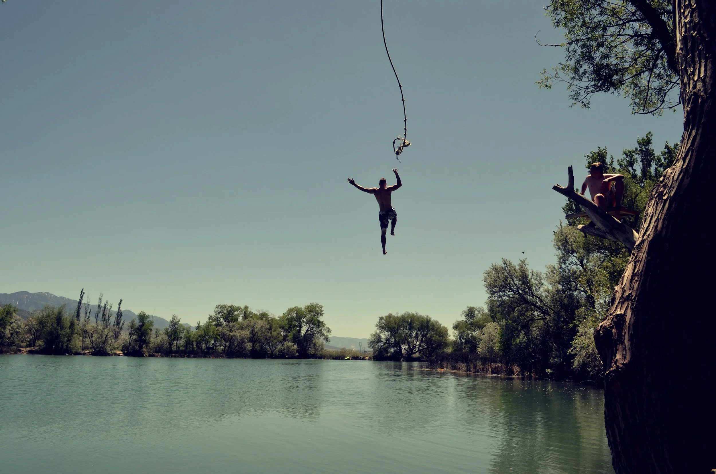 Person jumping joyfully against a golden sunset sky — representing freedom and possibility