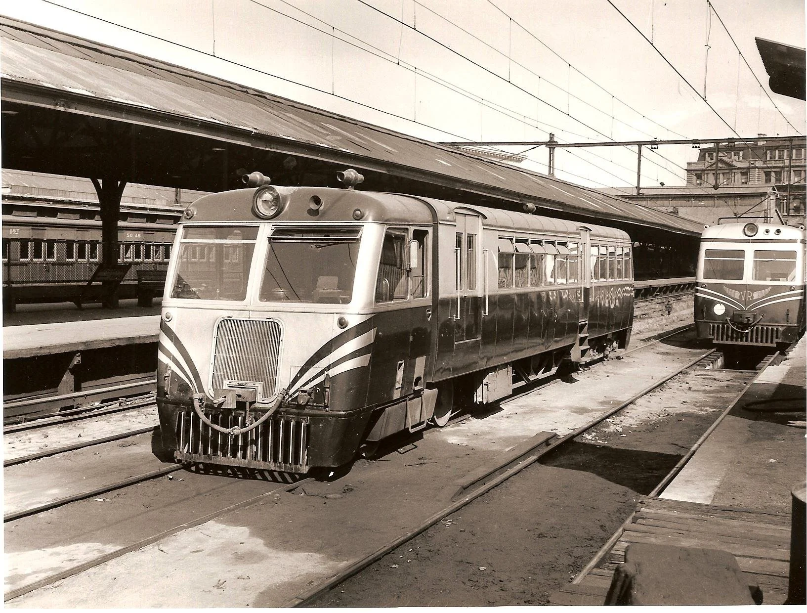 102hp Walker railcar in the early 1950s blue and silver livery at Spencer St Station with a blue and silver 280hp Walker in the background.jpg