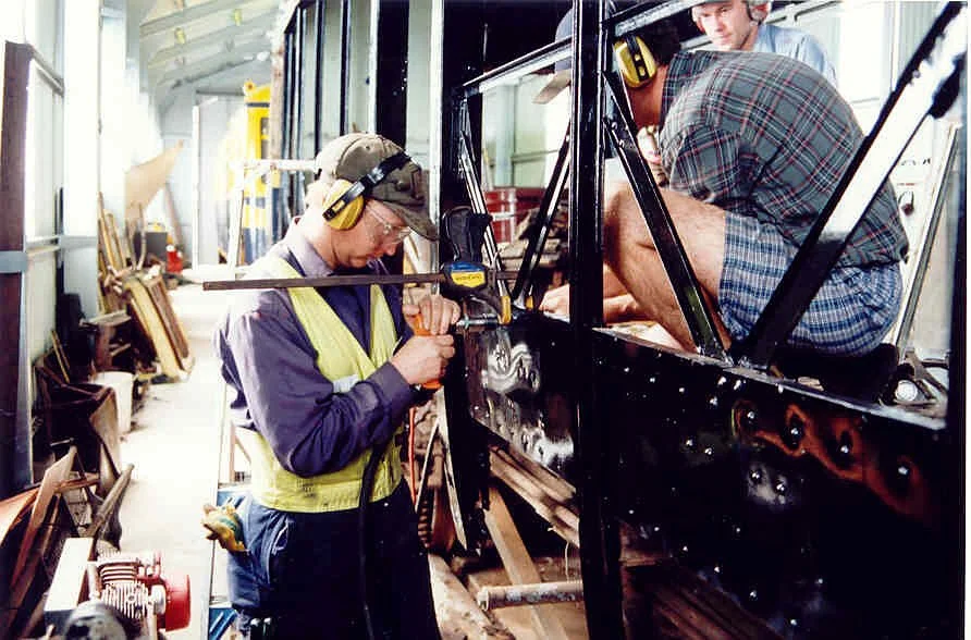 Rivetting new frame into place on 32.jpg
