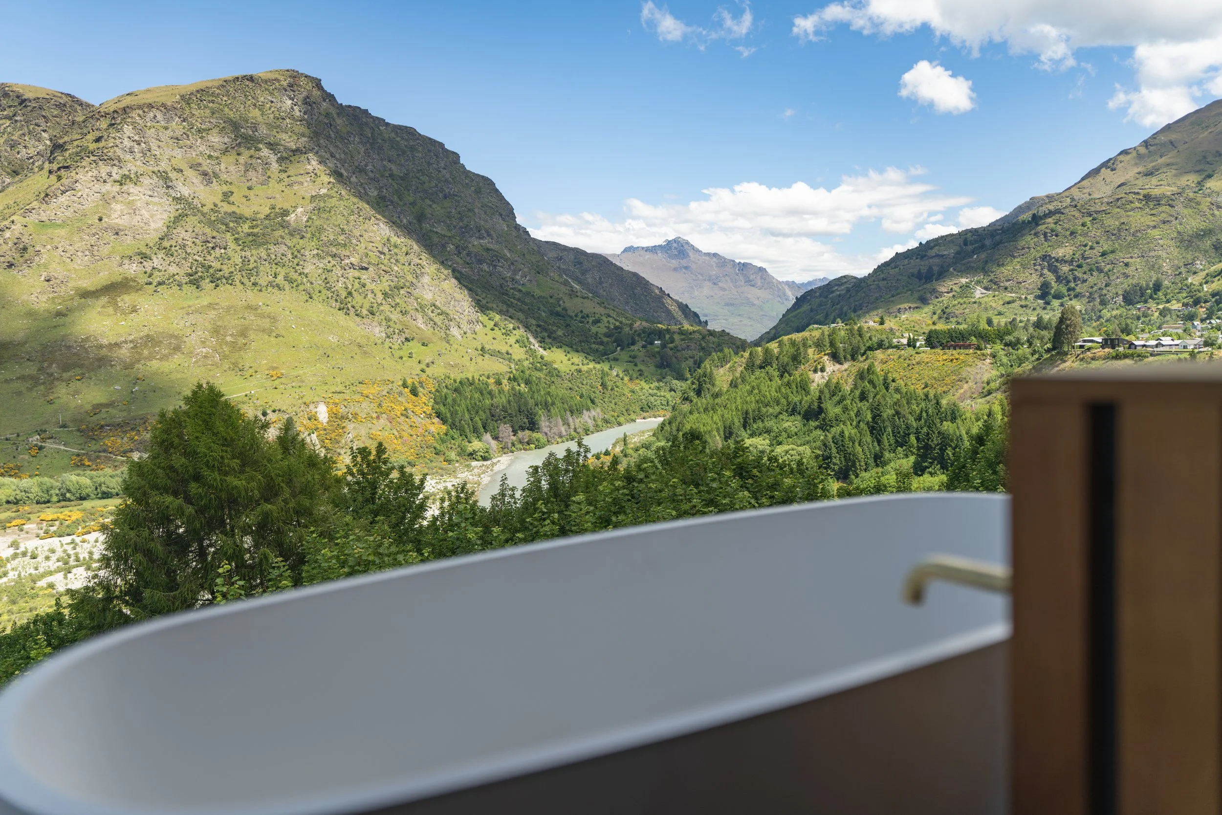 Balcony view overlooking alpine mountains and river valley