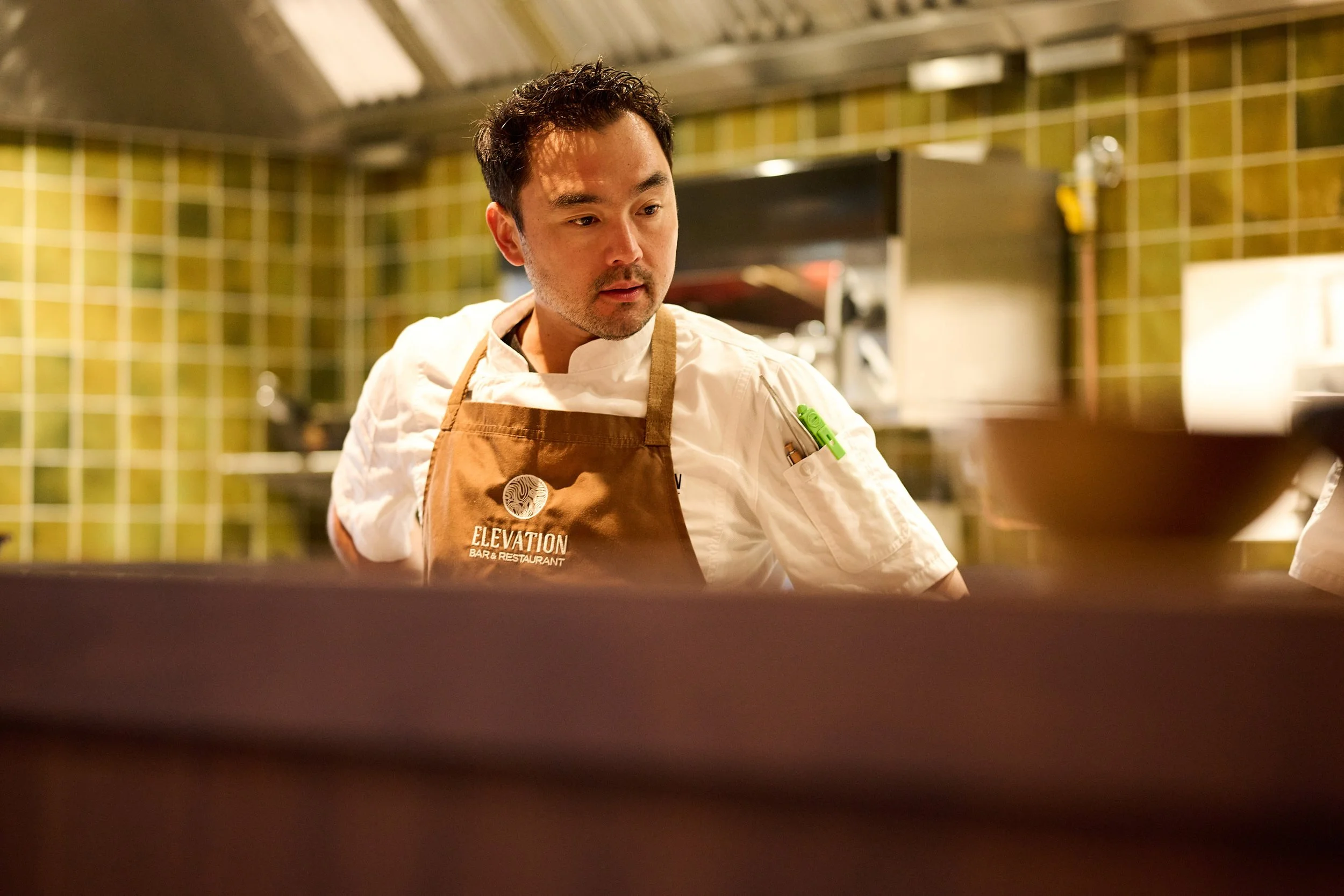 Chef at Elevation Bar & Restaurant Queenstown preparing dishes in the kitchen