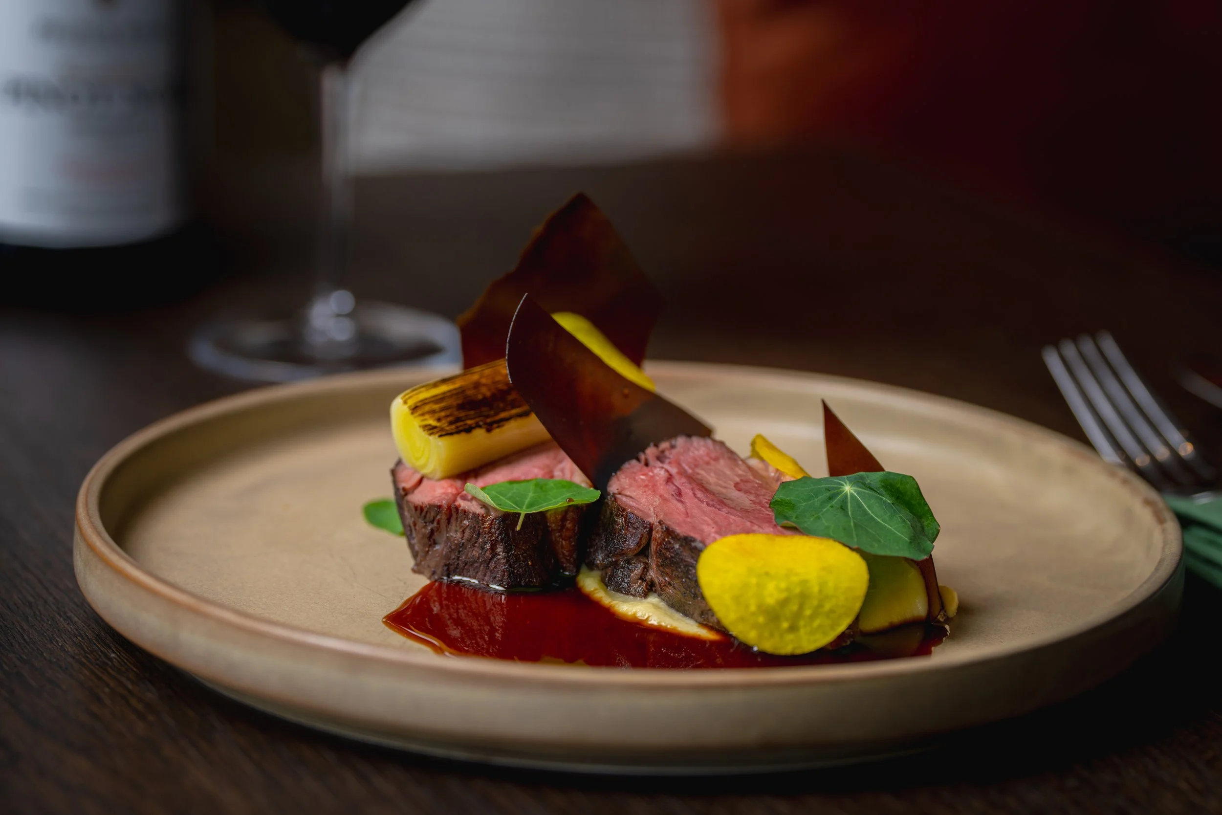 Fine dining beef dish at Elevation Bar & Restaurant Queenstown with seasonal vegetables and rich sauce