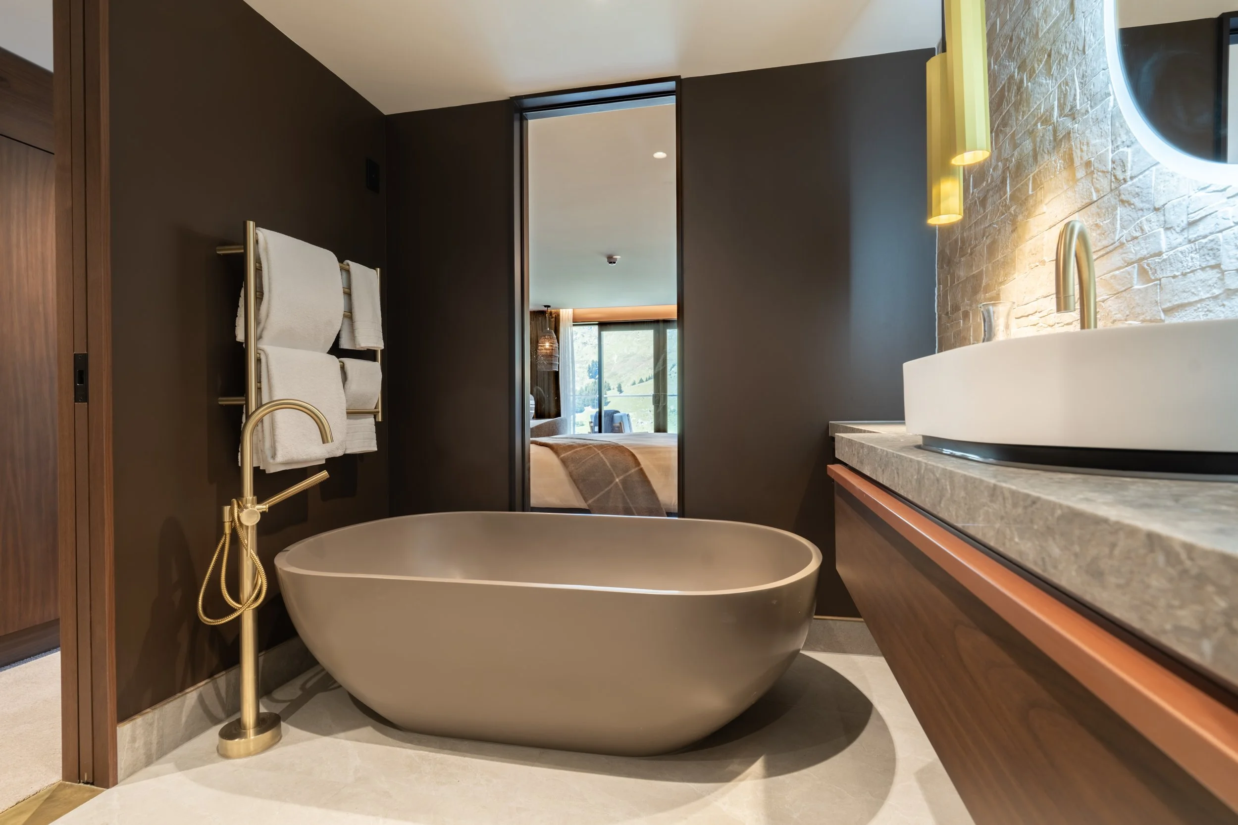 Modern ensuite bathroom with freestanding bathtub, timber vanity and soft lighting at Coronet Ridge Resort.