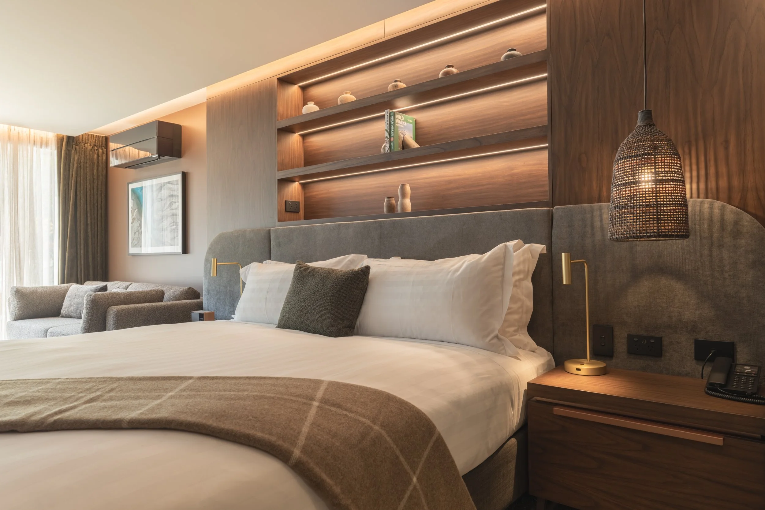 Spacious bedroom with plush bedding, built-in shelving and alpine-inspired design.