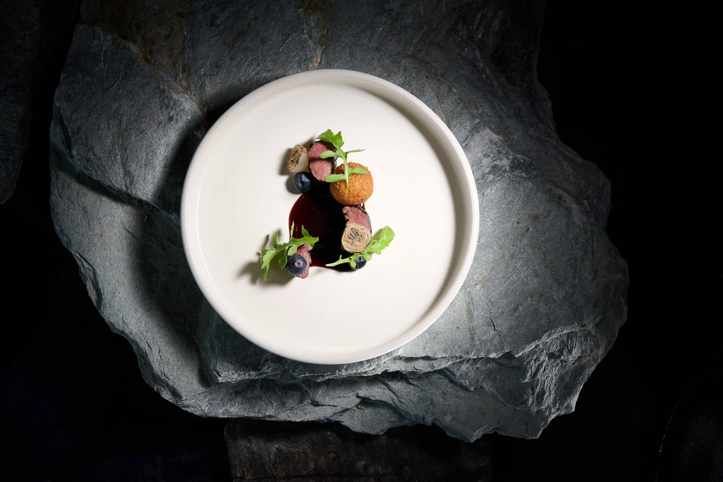 Fine dining dish at Elevation Queenstown with seasonal ingredients and artistic plating.