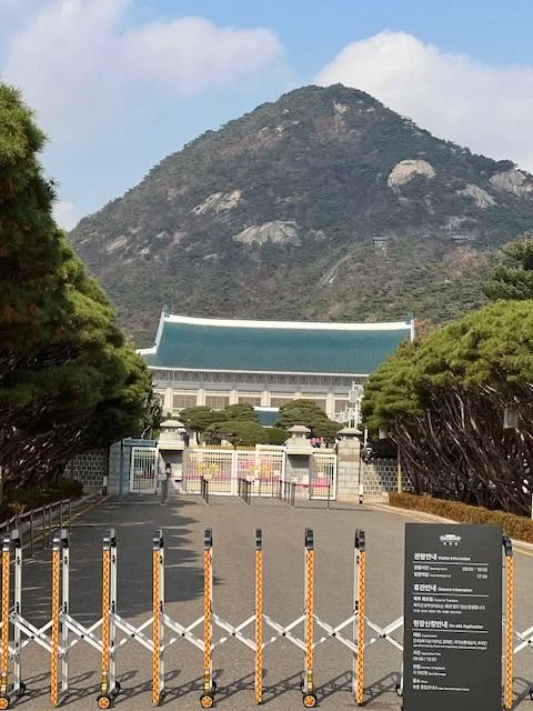 The Blue House with a mountain in the backdrop