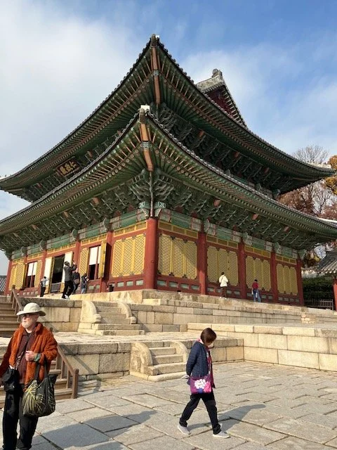 a Korean palace with tourists around