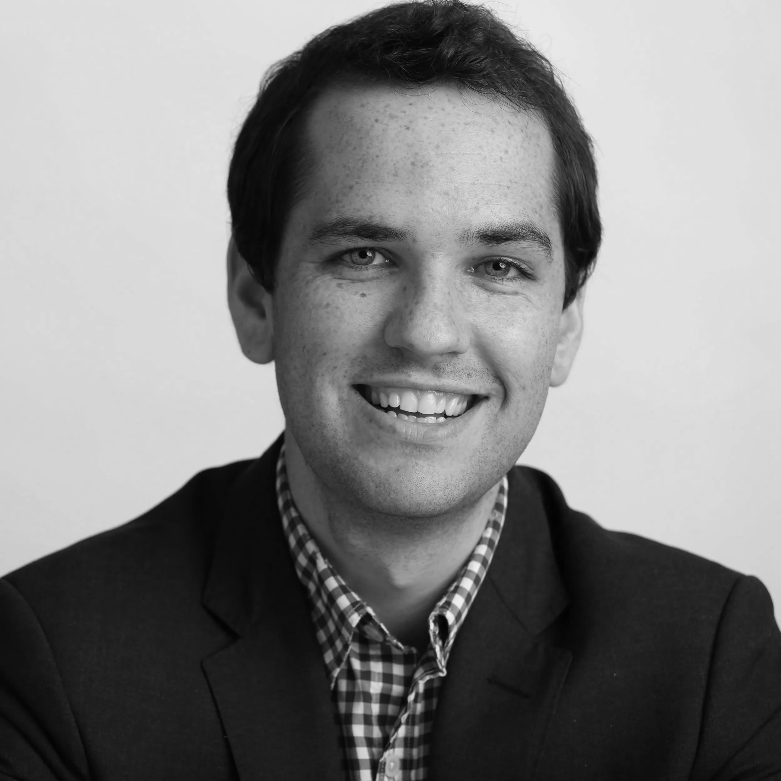 Black and white headshot photograph of Ezra Levin.