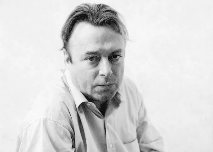 Black-and-white portrait of a man with short light hair, wearing a collared shirt, looking serious.