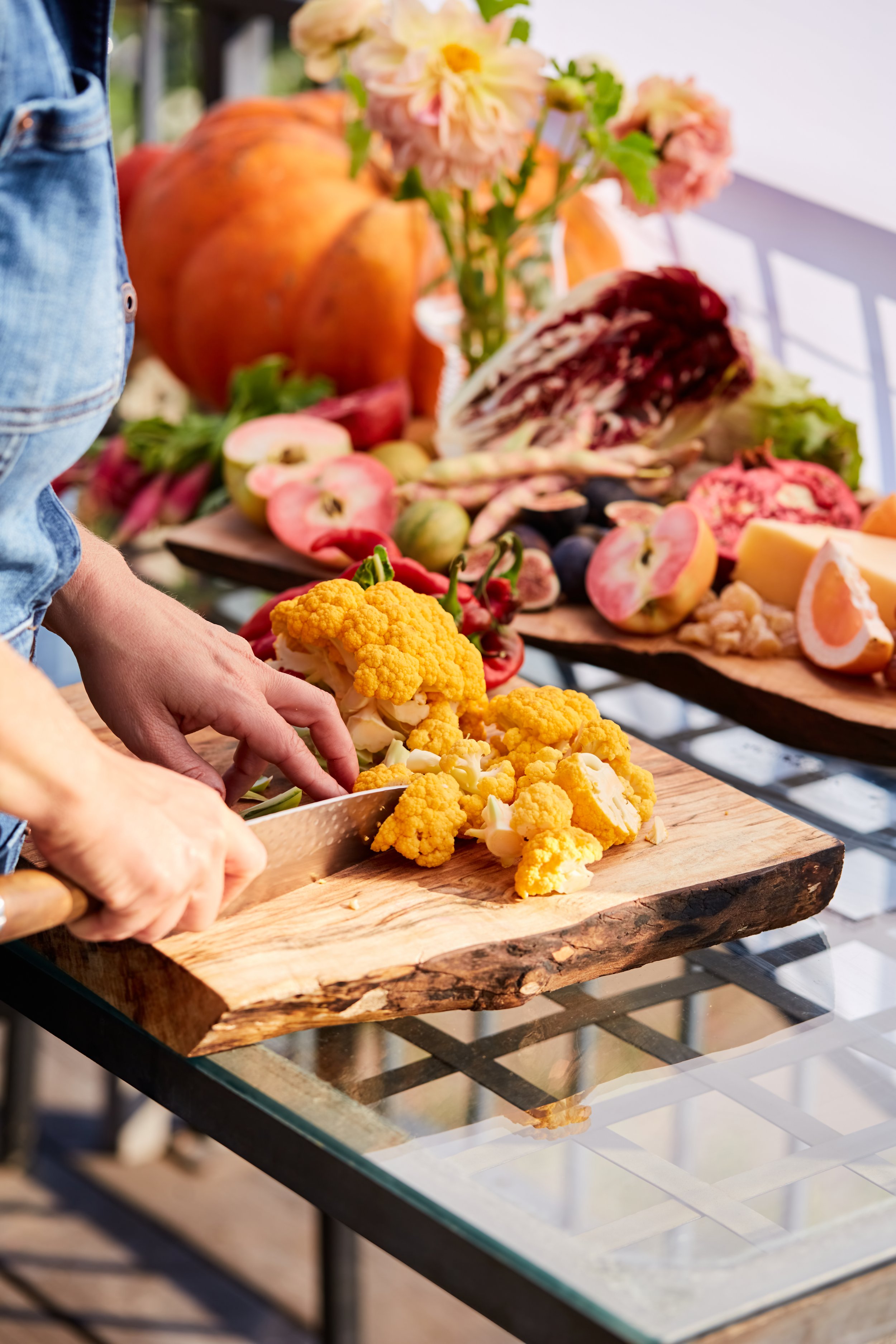 Close-up of Gather Around Nutrition chef expertly preparing fresh, seasonal vegetables with practiced precision, showcasing the craftsmanship and careful ingredient handling that transforms raw produce into nourishing, flavorful meals