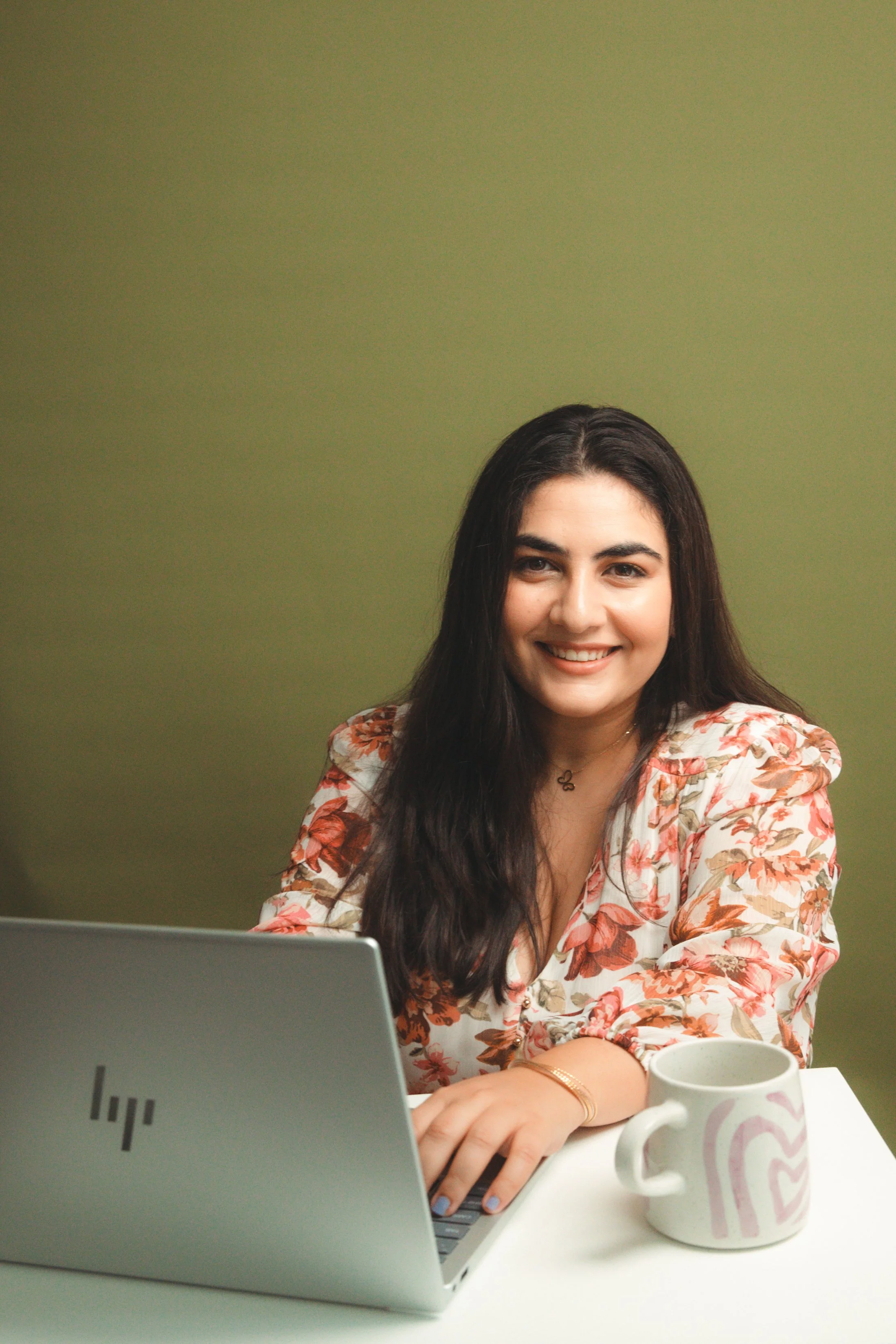 Karen on her laptop with a mug