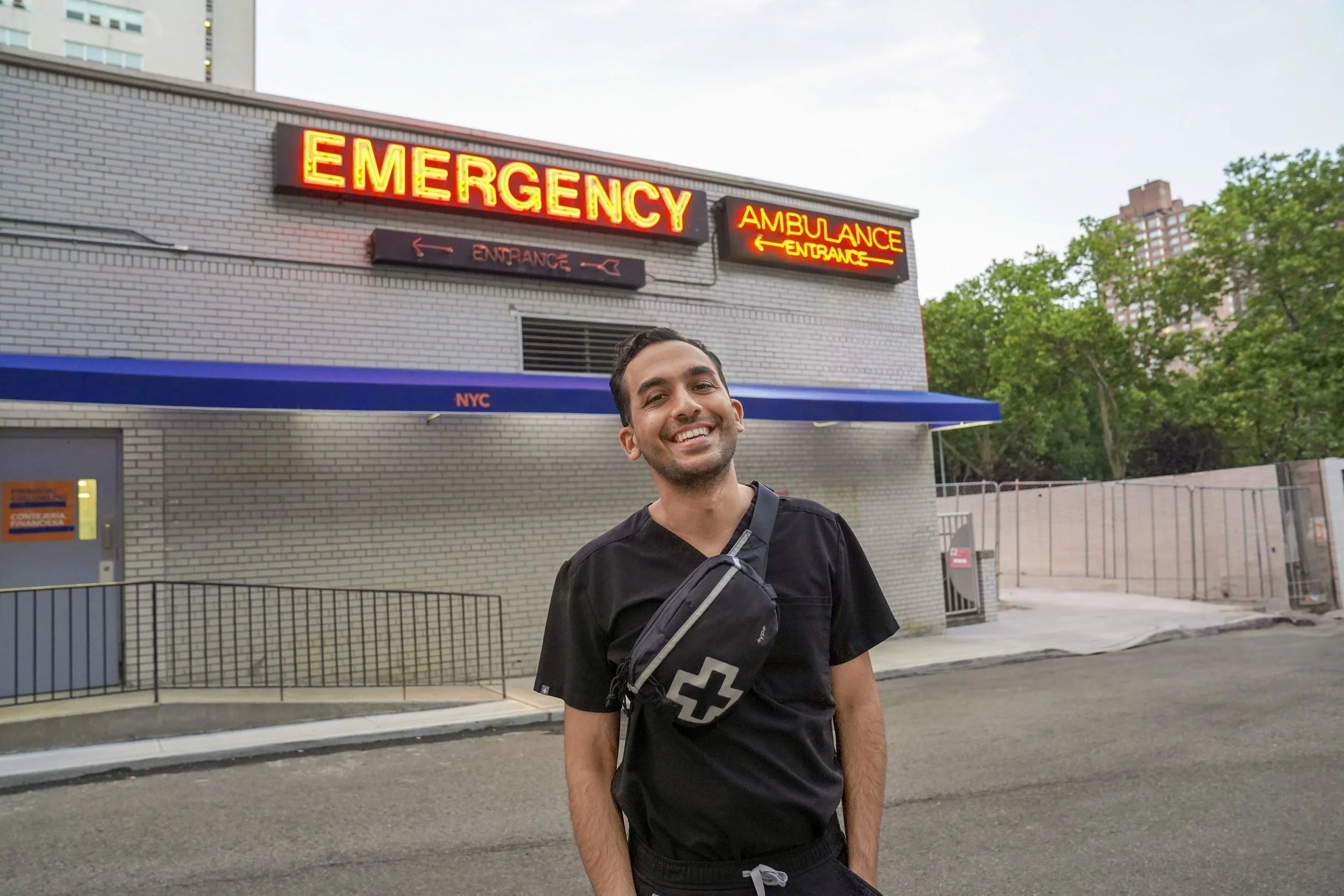 Person smiling in front of emergency entrance