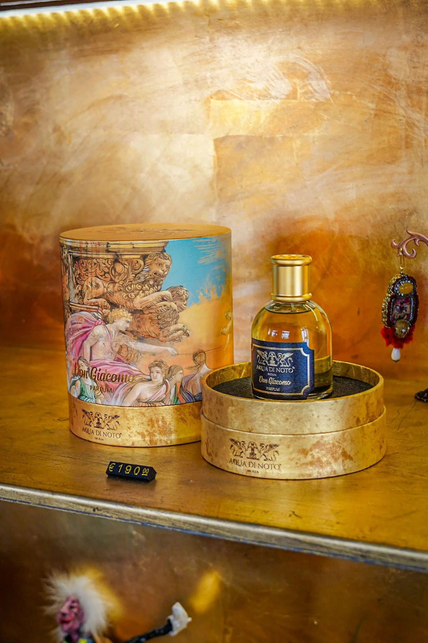 Acqua di Noto perfume bottle and decorative packaging on a wooden surface