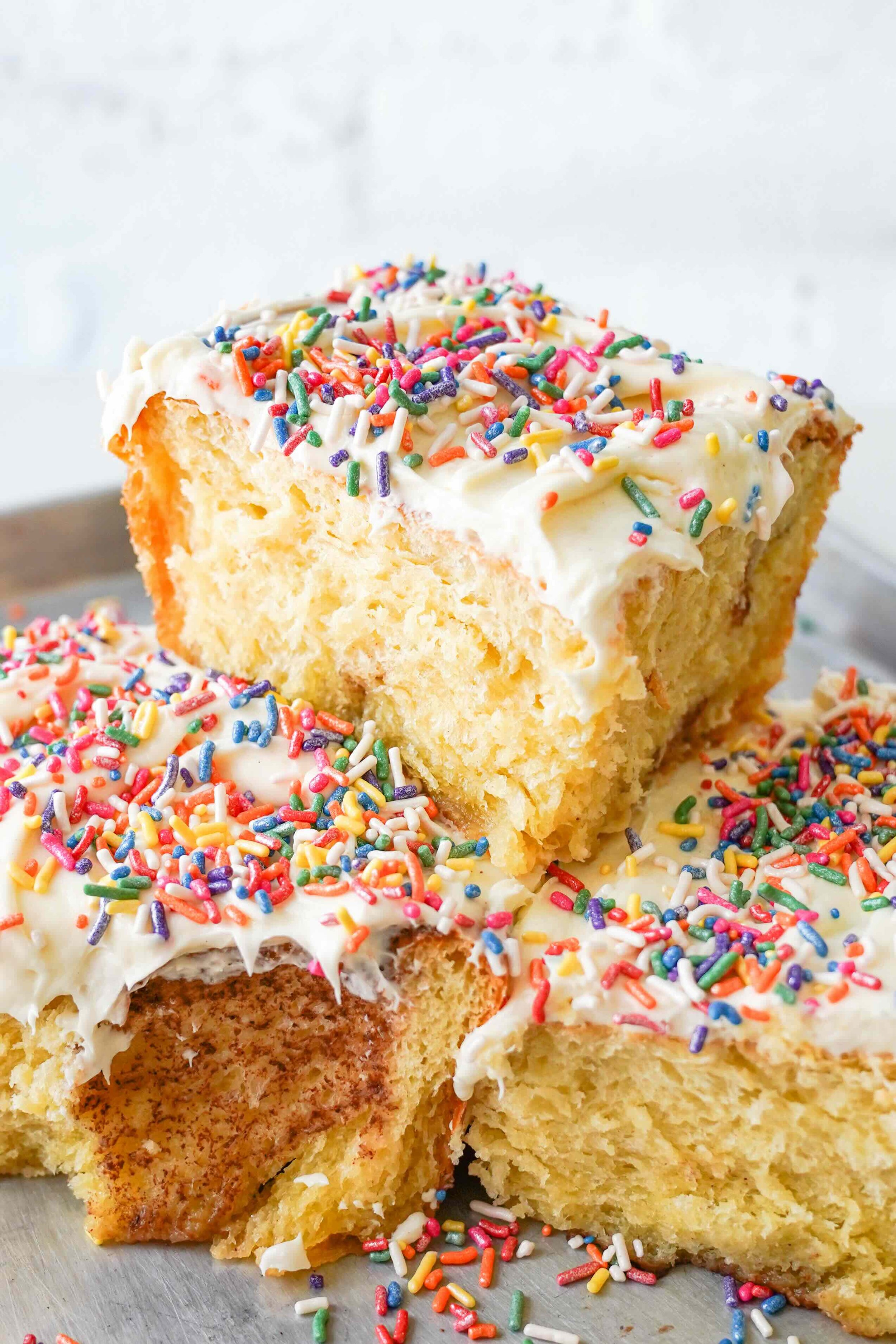 Close-up of slices of frosted cake with colorful sprinkles.
