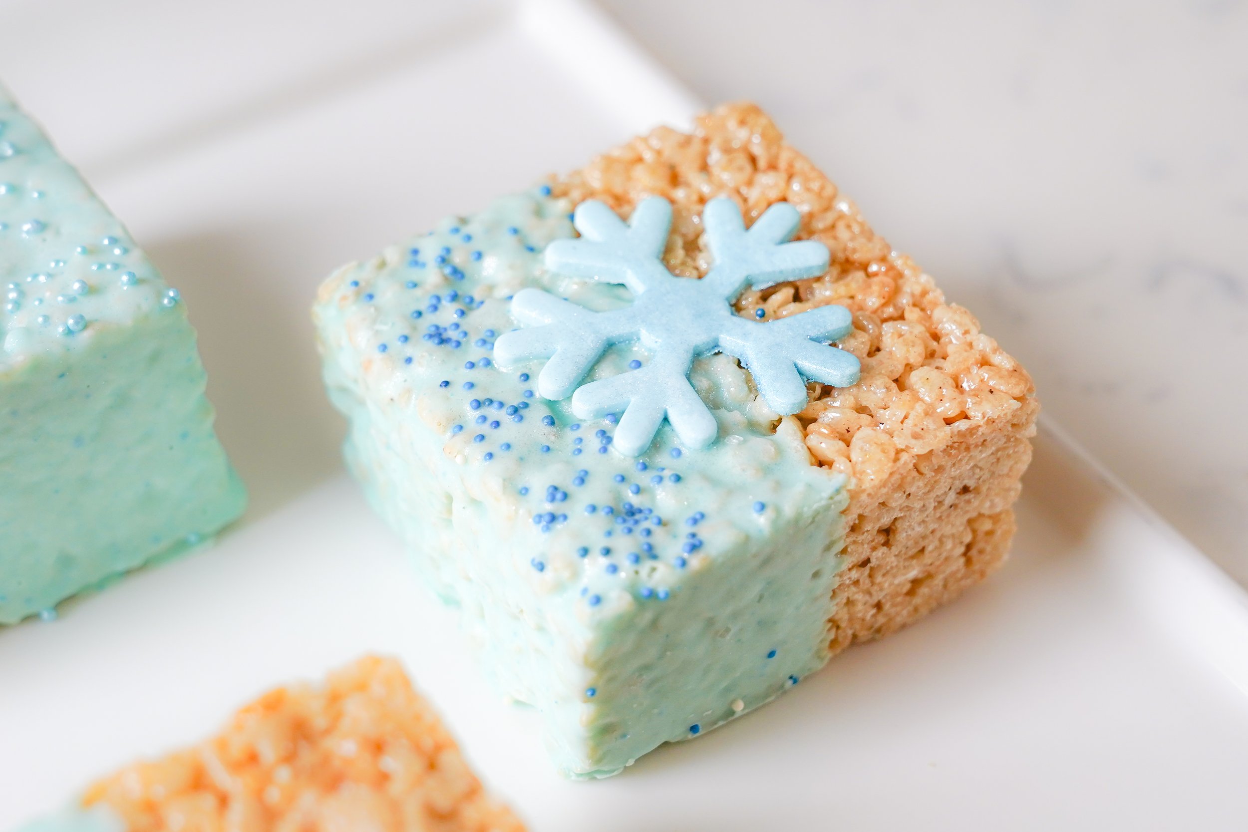 Rice Krispies treat with blue icing and a snowflake decoration