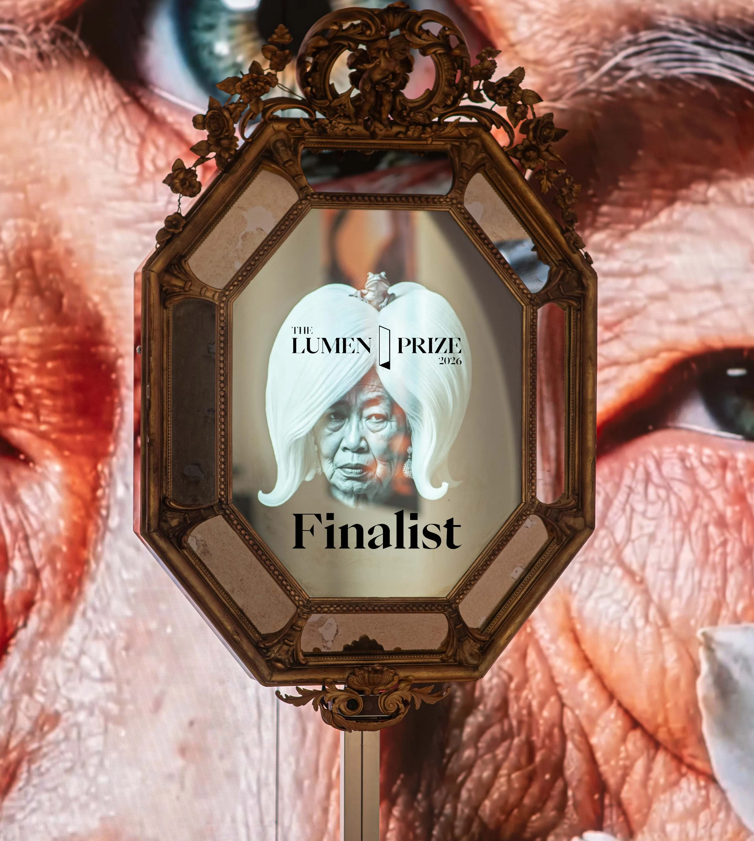 Mirror Into Auntieverse is a Lumen Prize Finalist 2026! Experiential Innovation Category. Mirror into Auntieverse is an interactive mirror that replaces your reflection with a speaking auntie who dishes out blunt, intimate remarks, exploring the voic