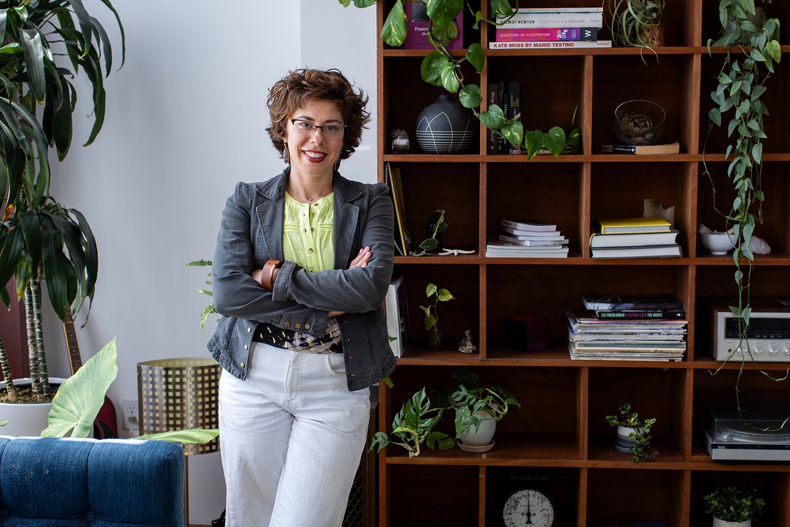 Jessica Lattif leaning against a bookshelf in her coaching office