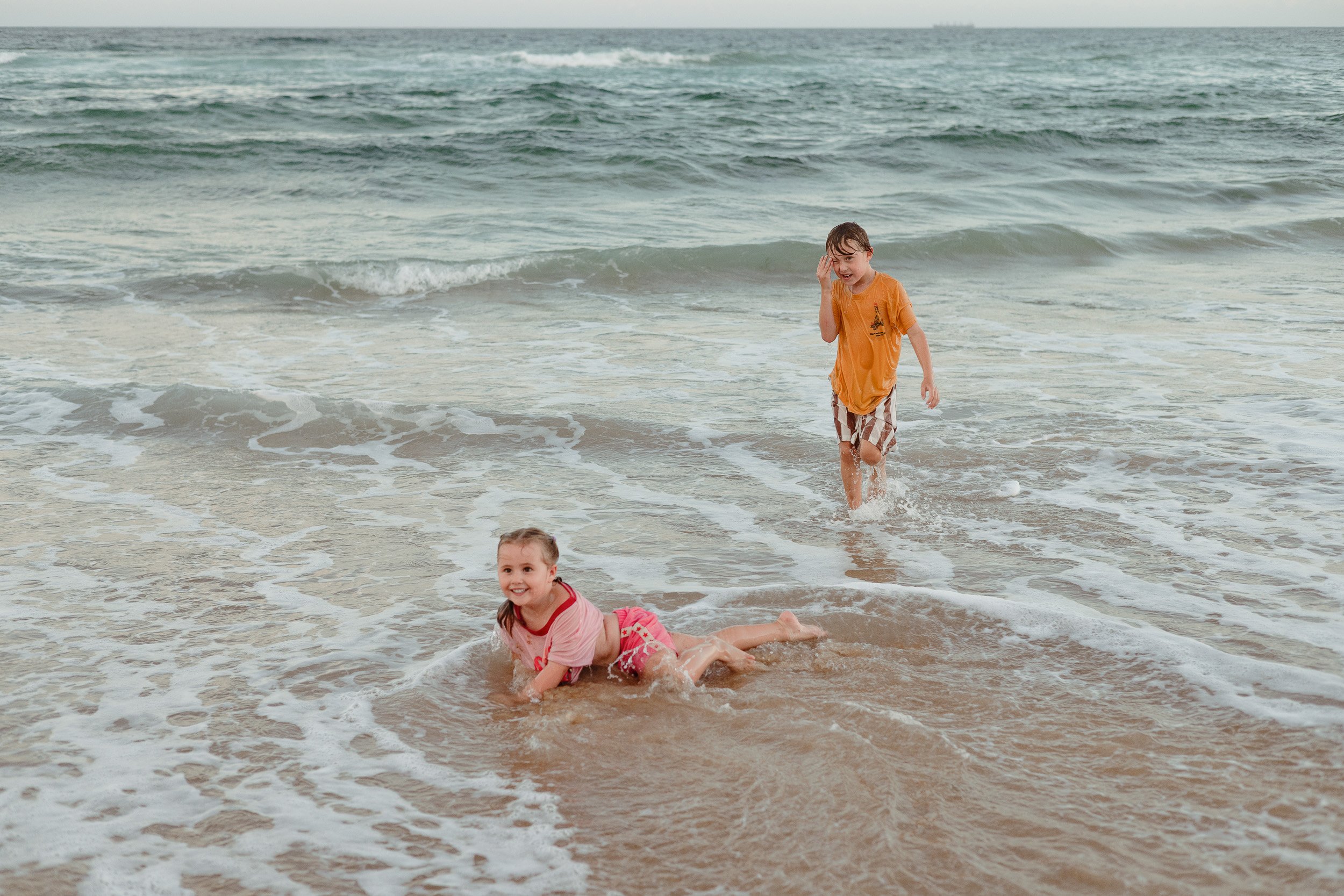 Kids jumping into the ocean at Merewether Beach captured by Newcastle family photographer