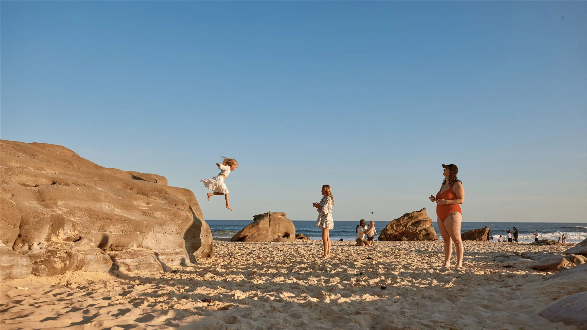 Toddler and primary school aged kids playing at Redhead Beach captured by Newcastle family photographer