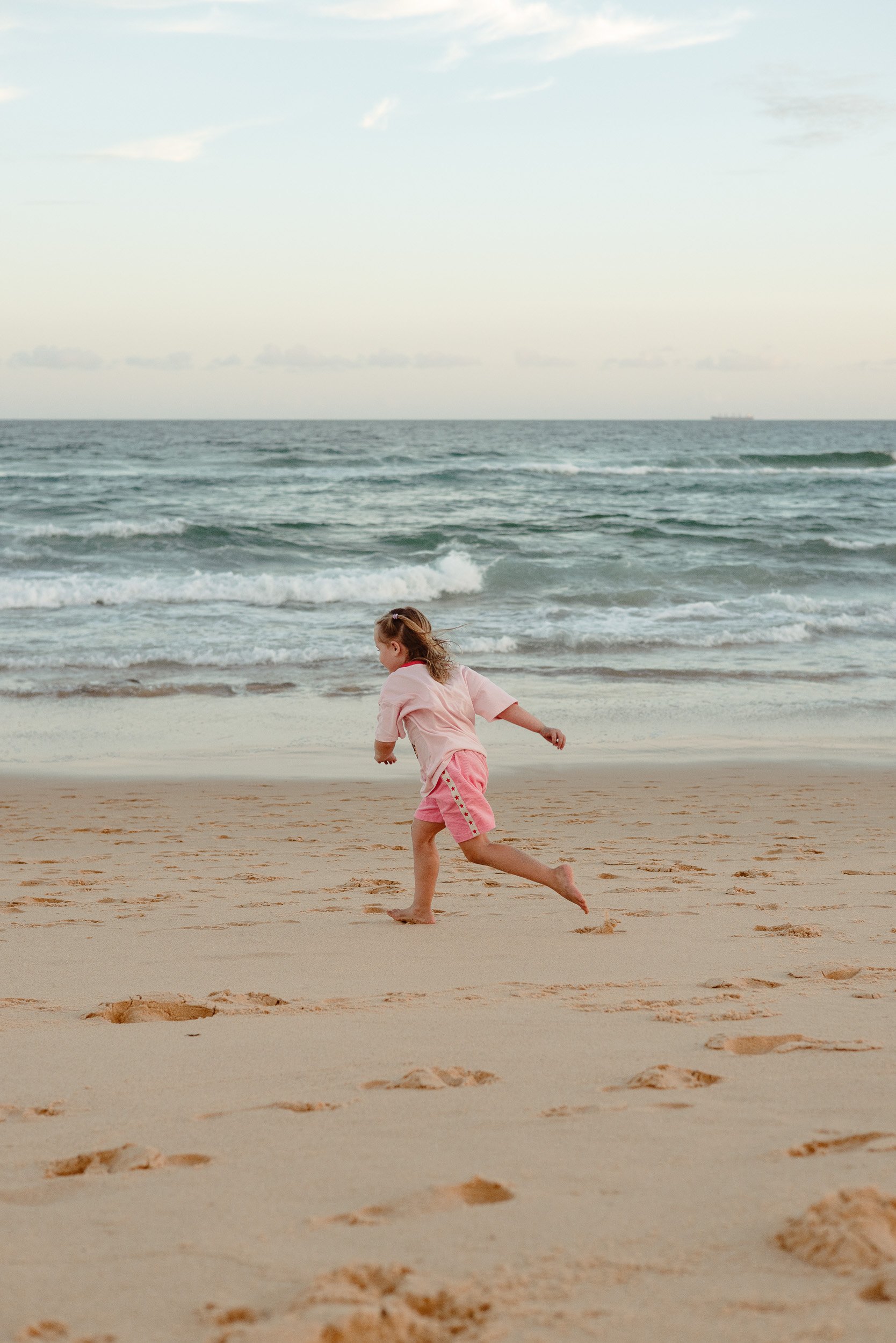 Kids jumping into the ocean at Merewether Beach captured by Newcastle family photographer