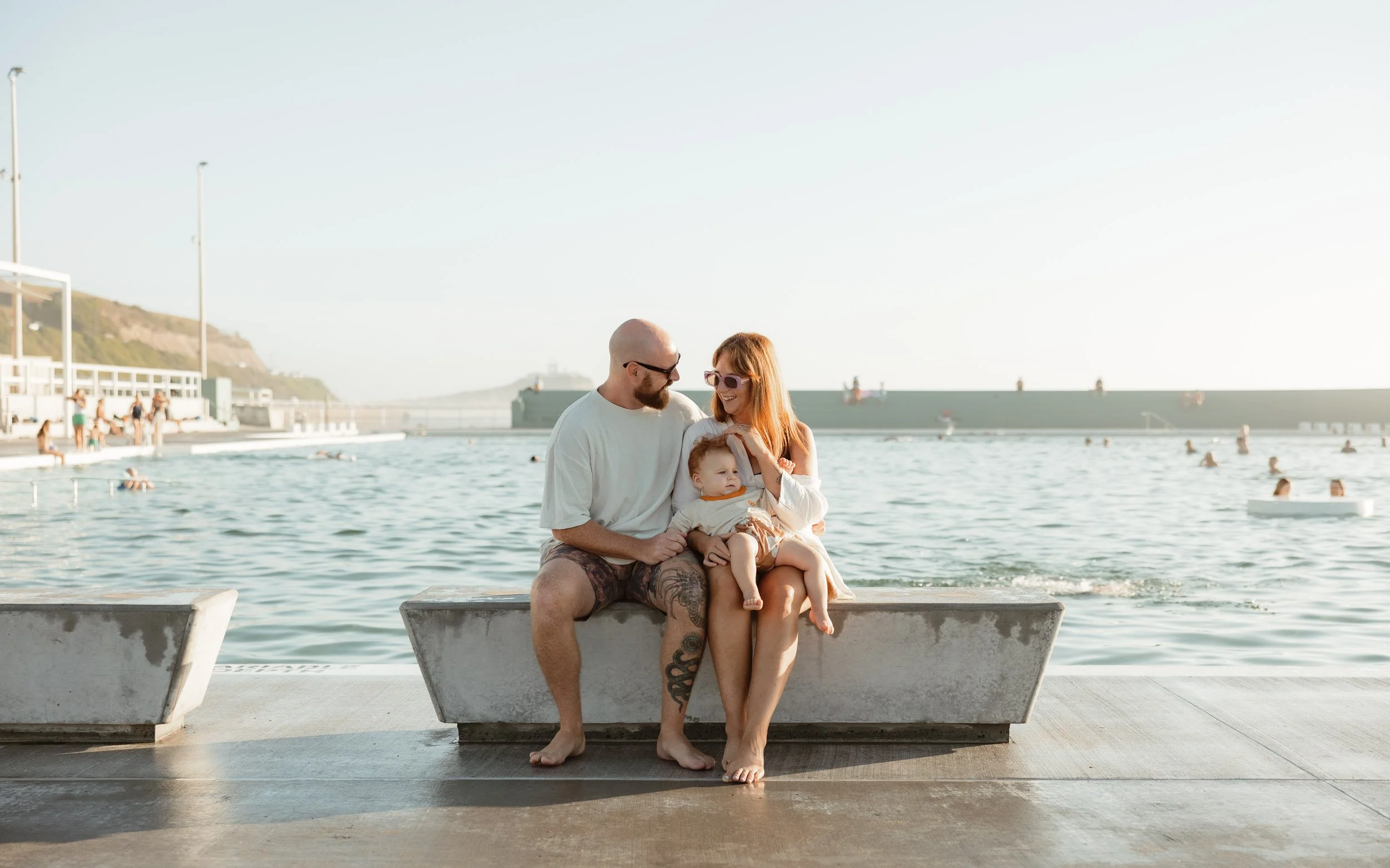 Newcastle documentary family photographer captures mum dad and baby at Newcastle Ocean Baths