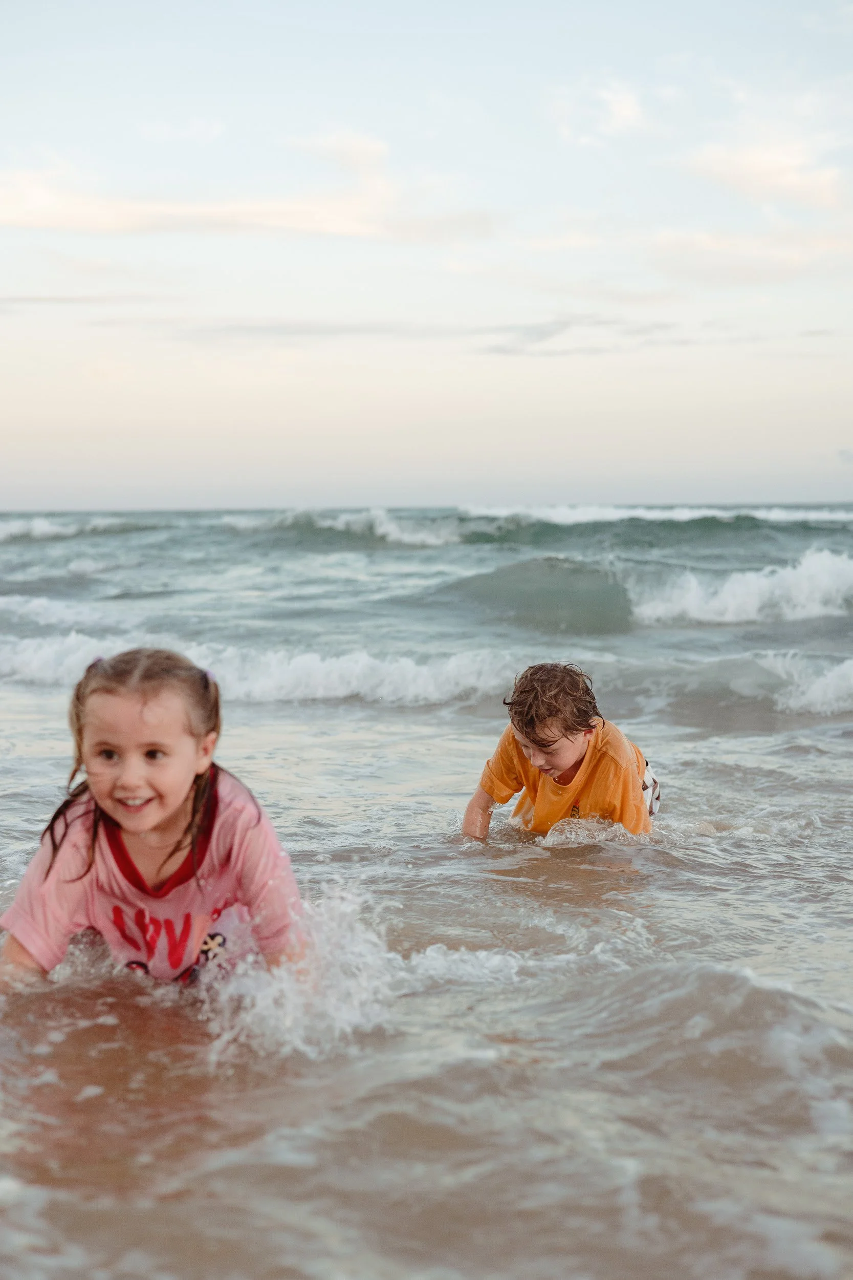 Kids jumping into the ocean at Merewether Beach captured by Newcastle family photographer