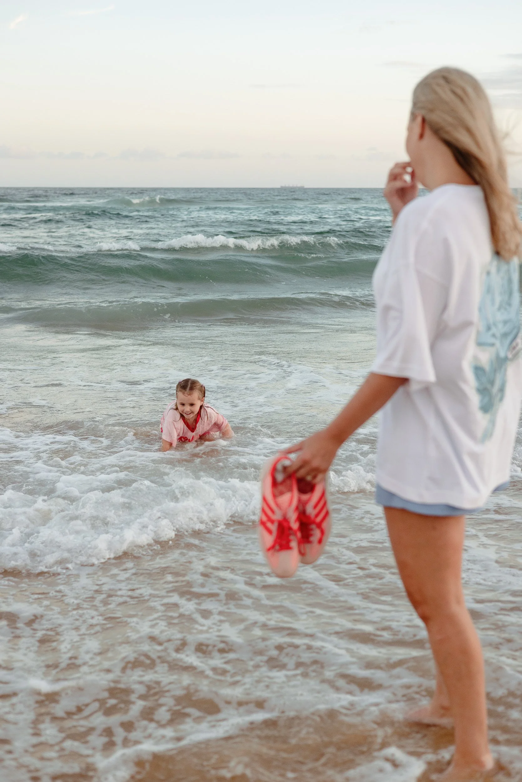 Kids jumping into the ocean at Merewether Beach captured by Newcastle family photographer