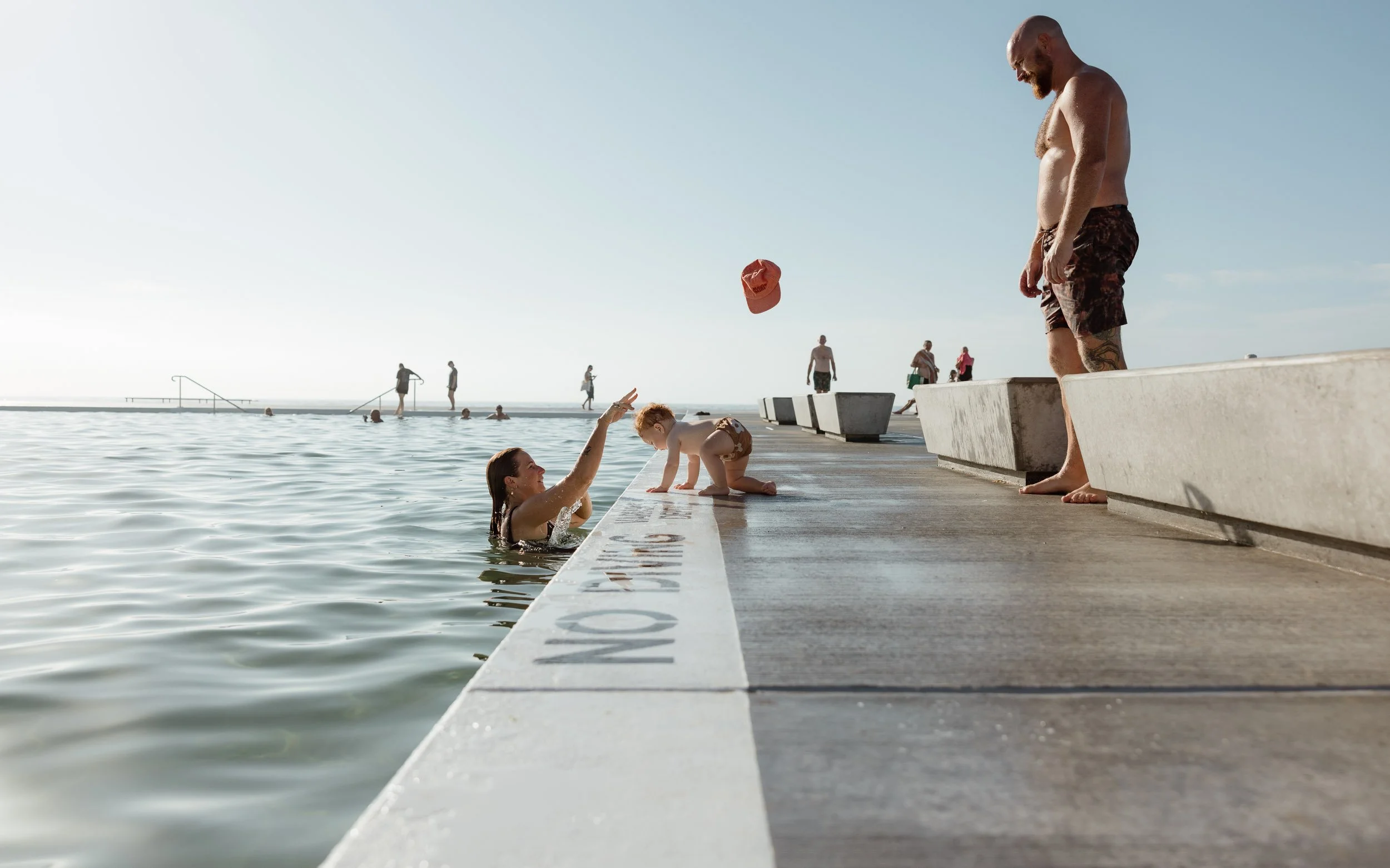 Natural and candid family moments at Newcastle Ocean Baths by Daina Marie Photography