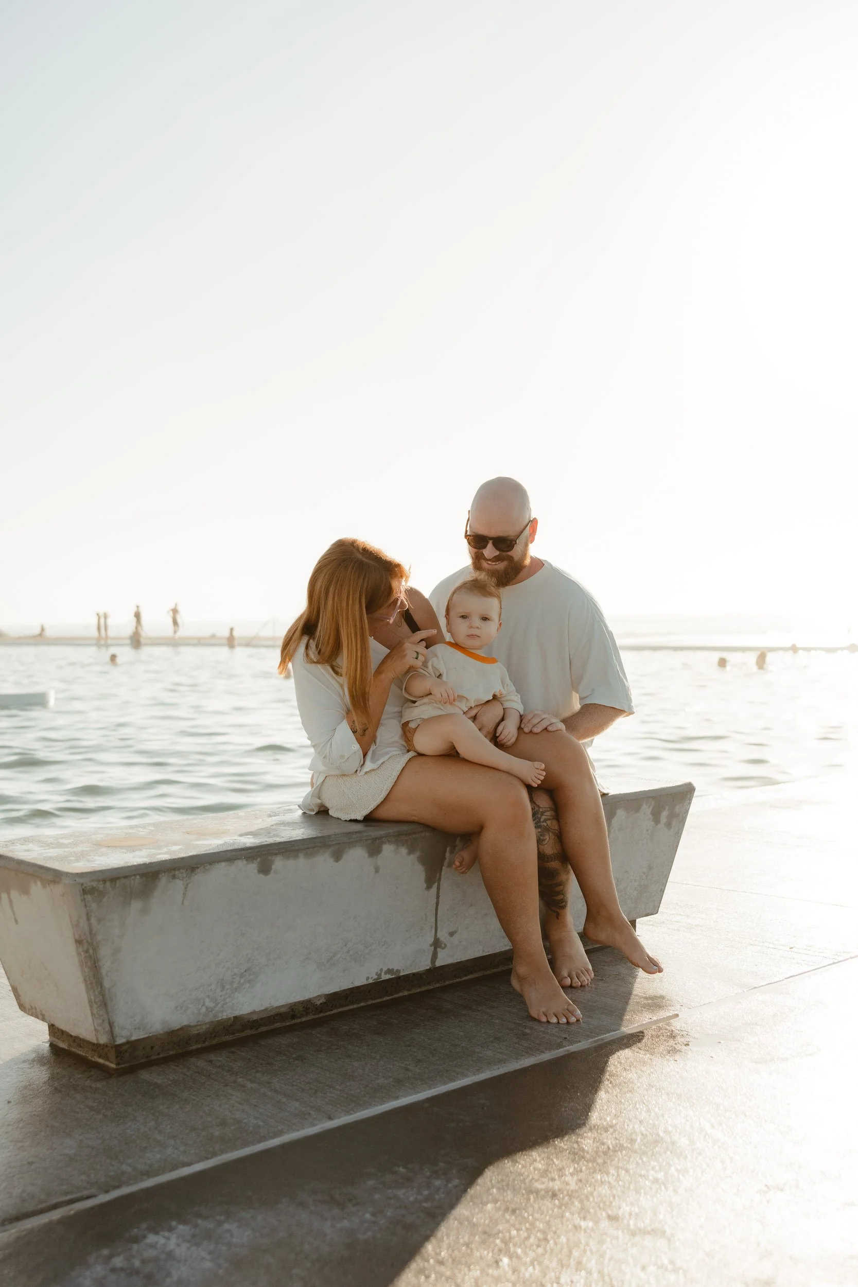 Young family enjoying summer at Newcastle Ocean Baths captured by Newcastle family photographer