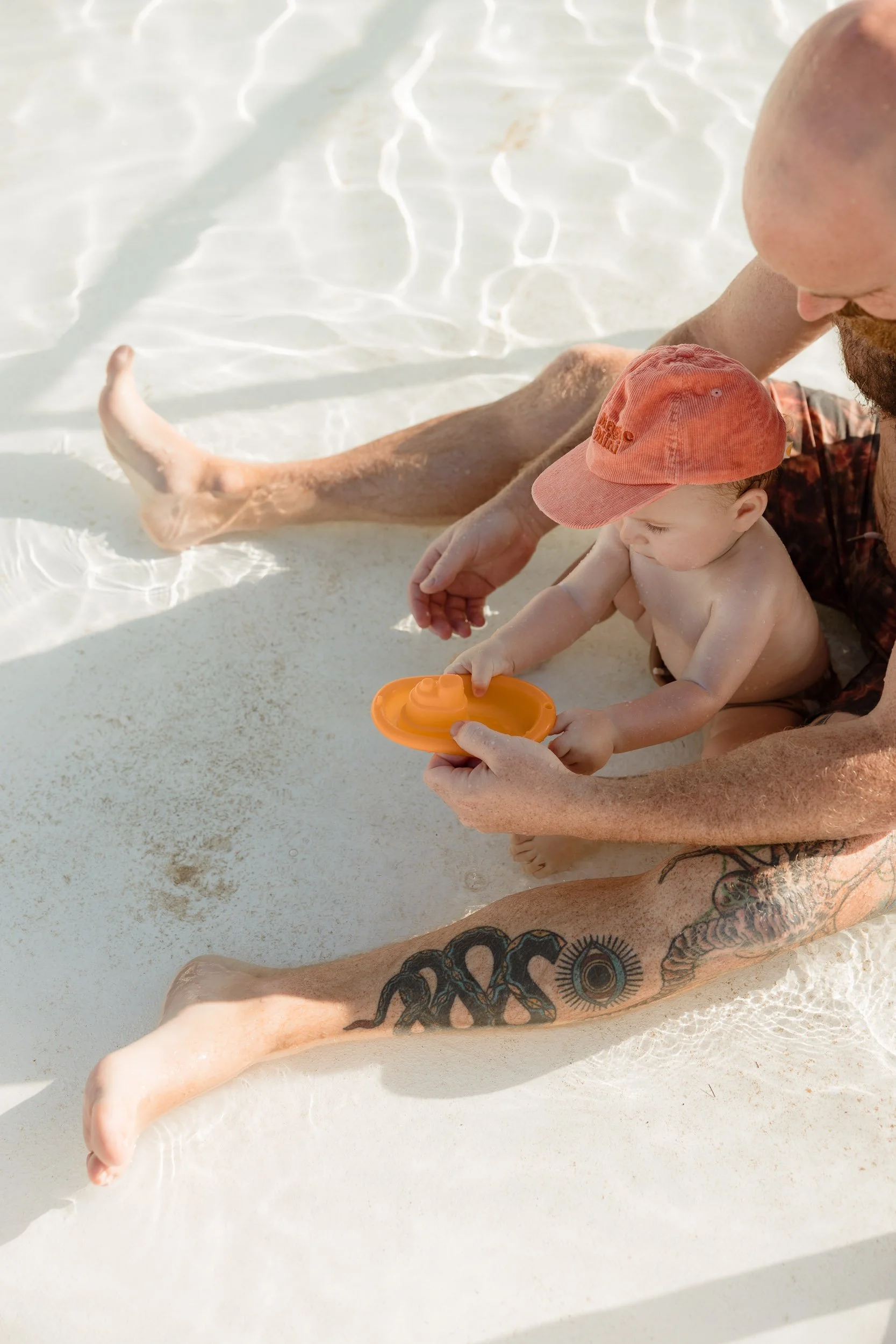 Newcastle documentary family photographer captures mum dad and baby at Newcastle Ocean Baths