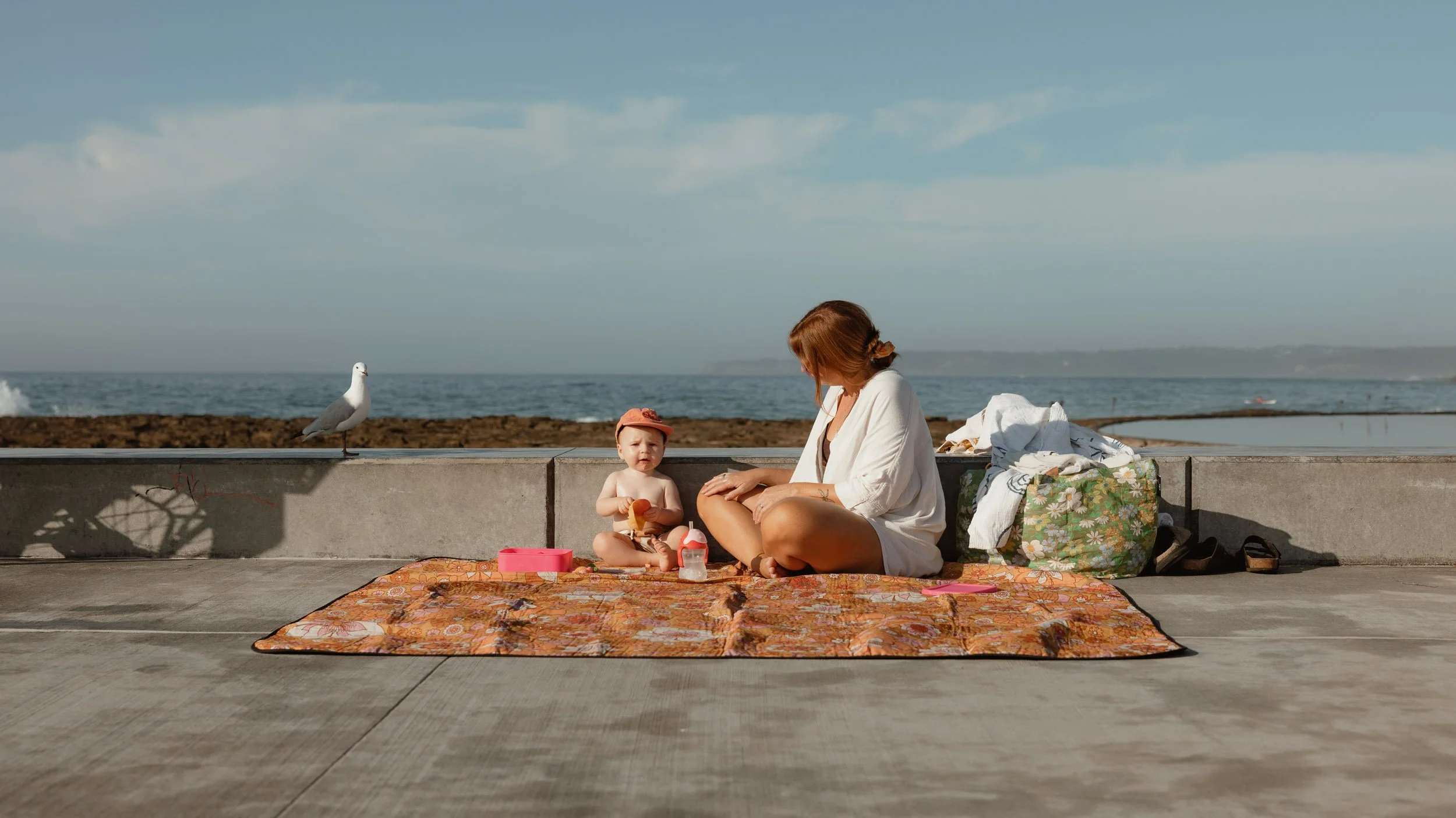 Young family enjoying summer at Newcastle Ocean Baths captured by Newcastle family photographer