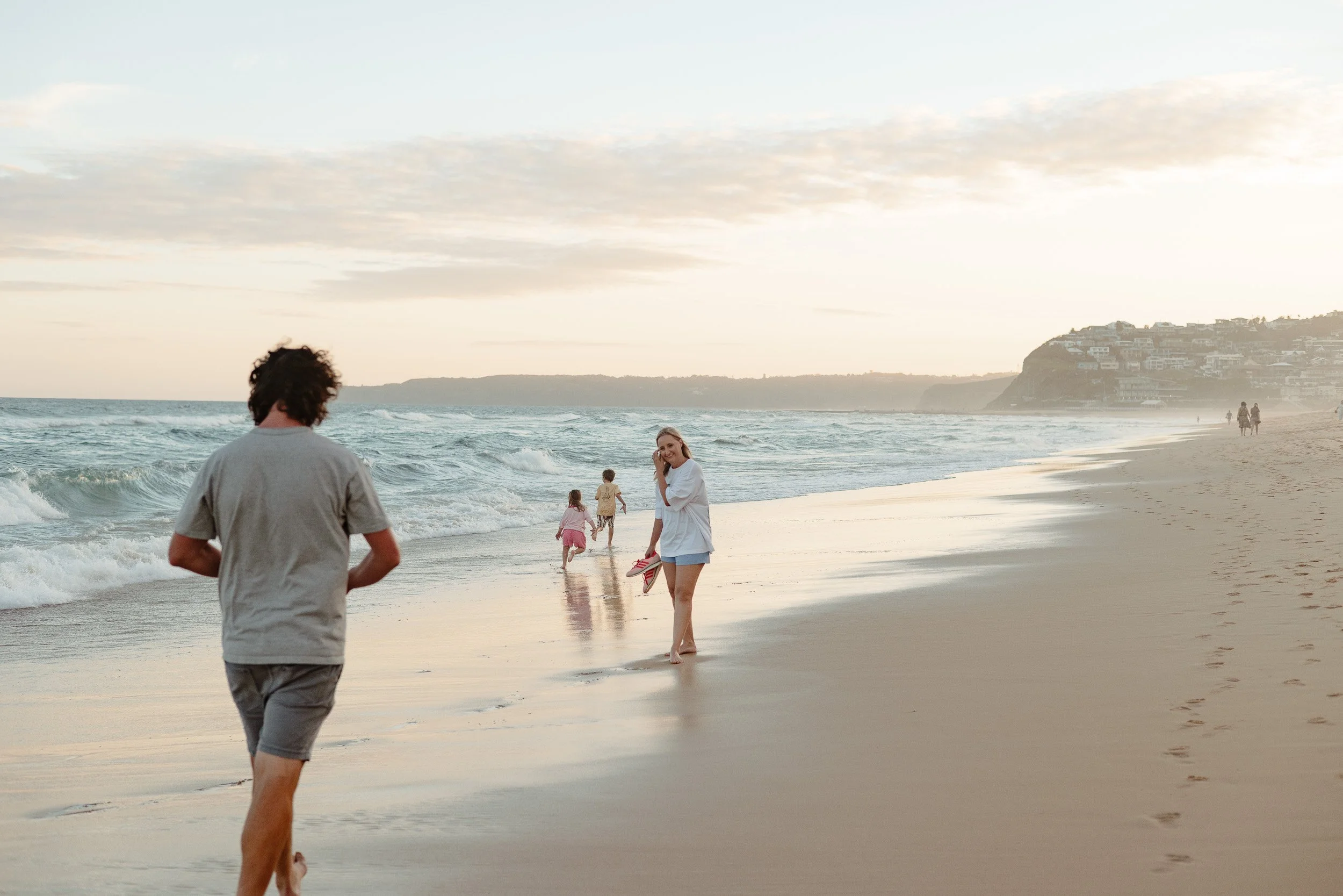 Kids jumping into the ocean at Merewether Beach captured by Newcastle family photographer