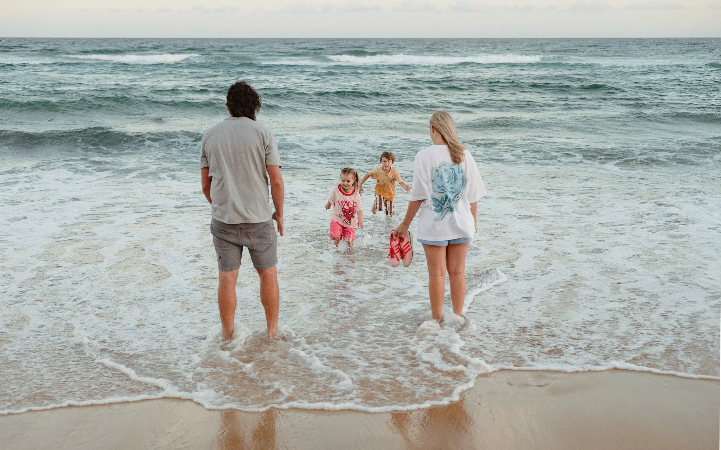 Kids jumping into the ocean at Merewether Beach captured by Newcastle family photographer