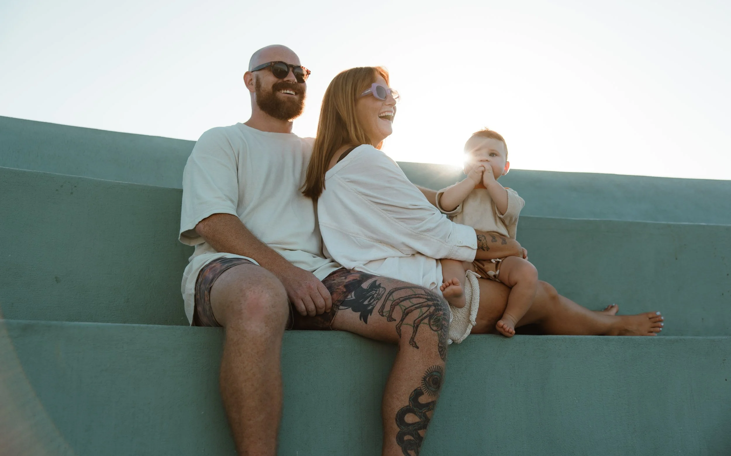 Newcastle documentary family photographer captures mum dad and baby at Newcastle Ocean Baths